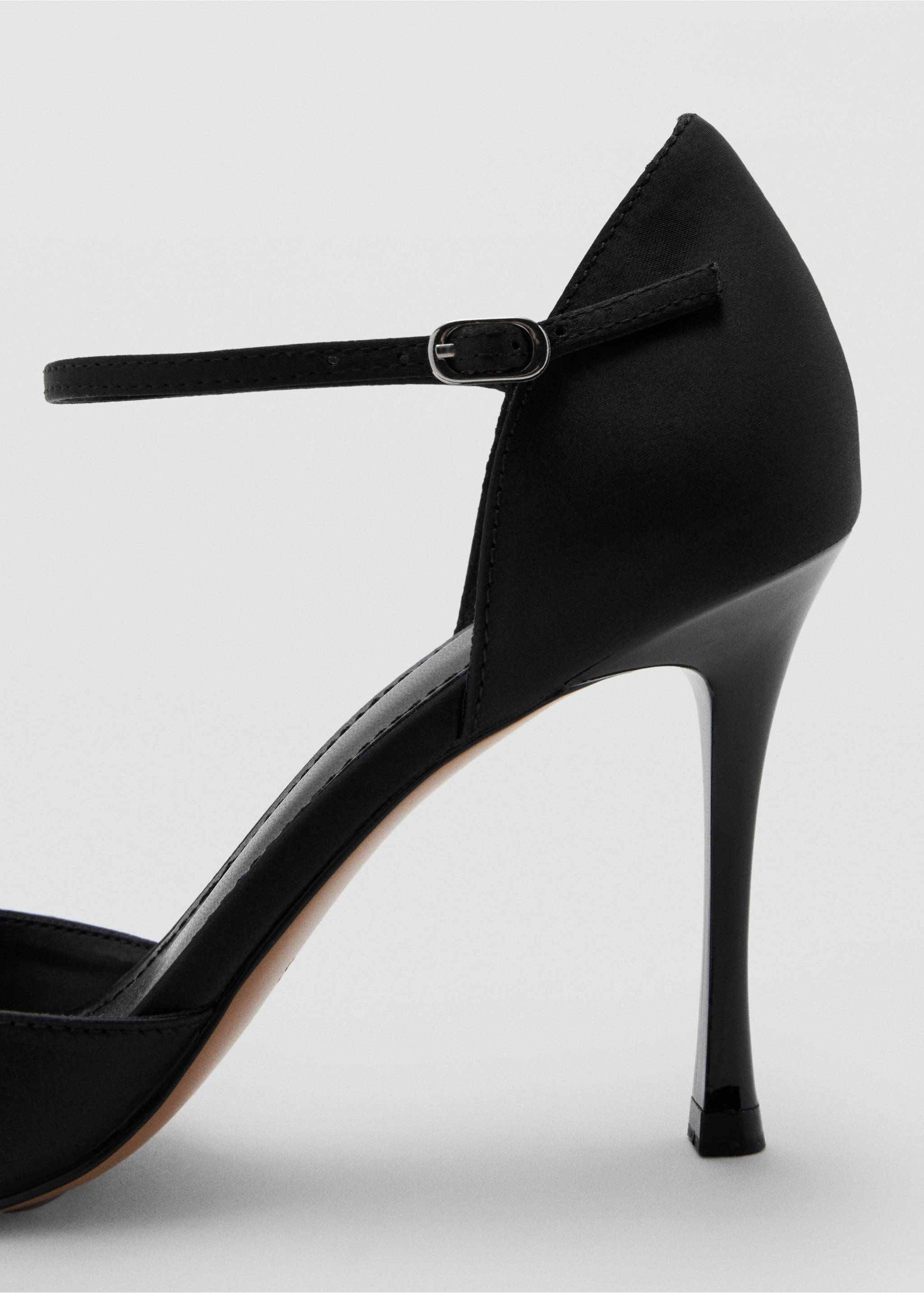 Close-up of a black heeled sandal featuring a slim stiletto heel and an ankle strap with a metal buckle., Black. Ref: 17099405-00.