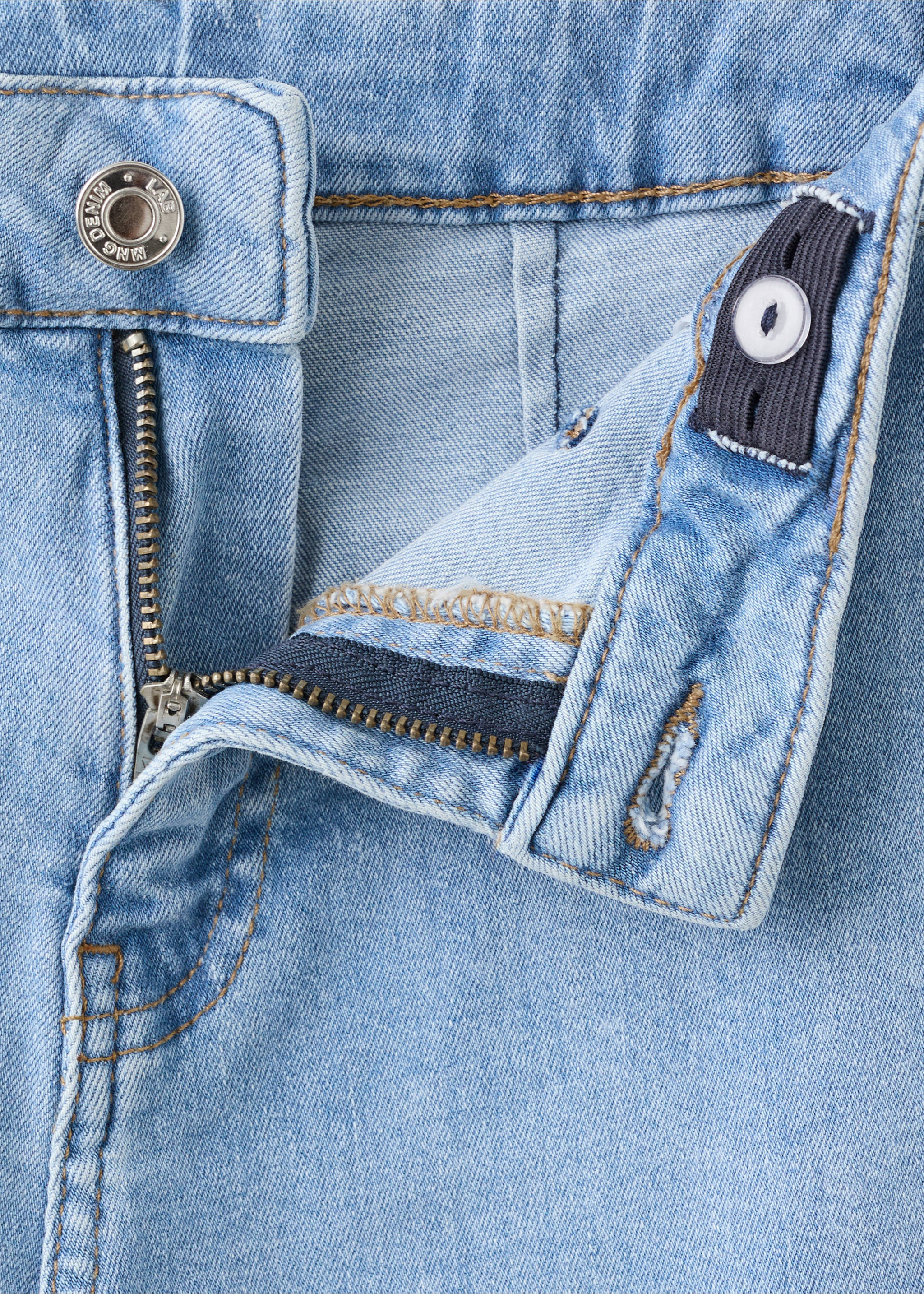 Light-wash blue denim trousers fly and waistband detail., Medium Blue. Ref: 27001259-00.