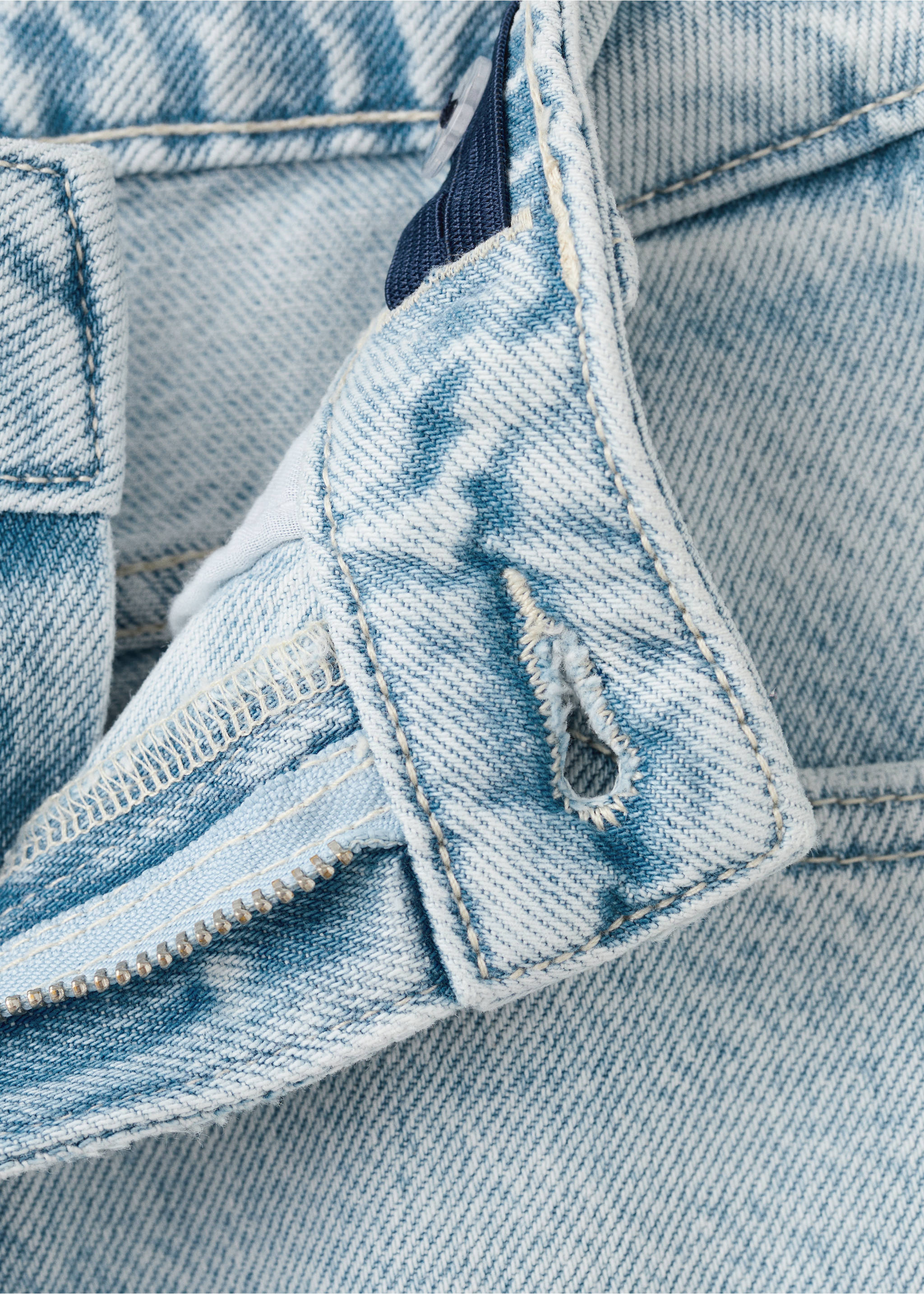 Close-up of light blue denim trousers waistband with buttonhole., Light Blue. Ref: 27001266-00.