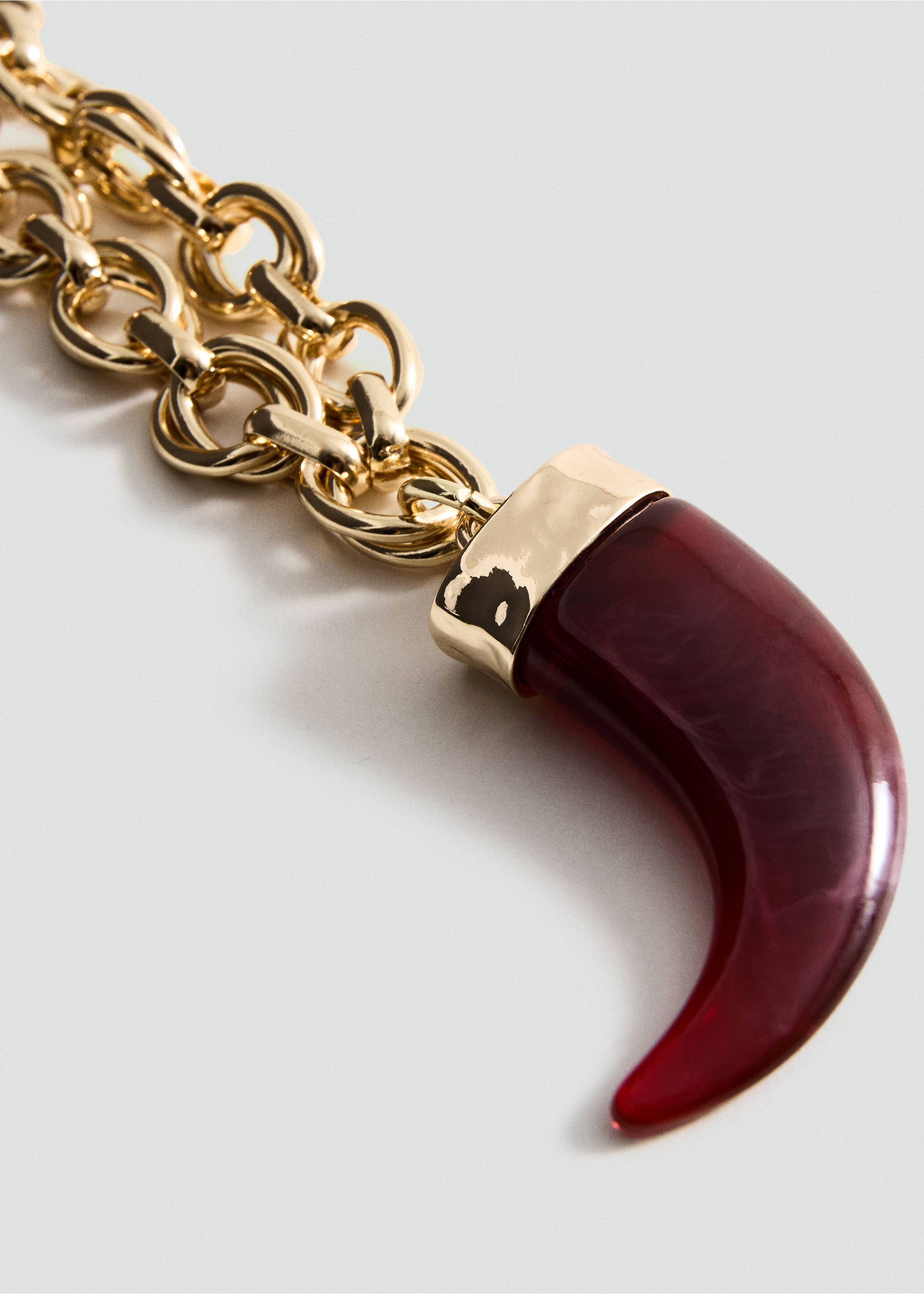 Gold-tone chain necklace featuring a curved burgundy resin tusk pendant., Gold. Ref: 27004787-00.