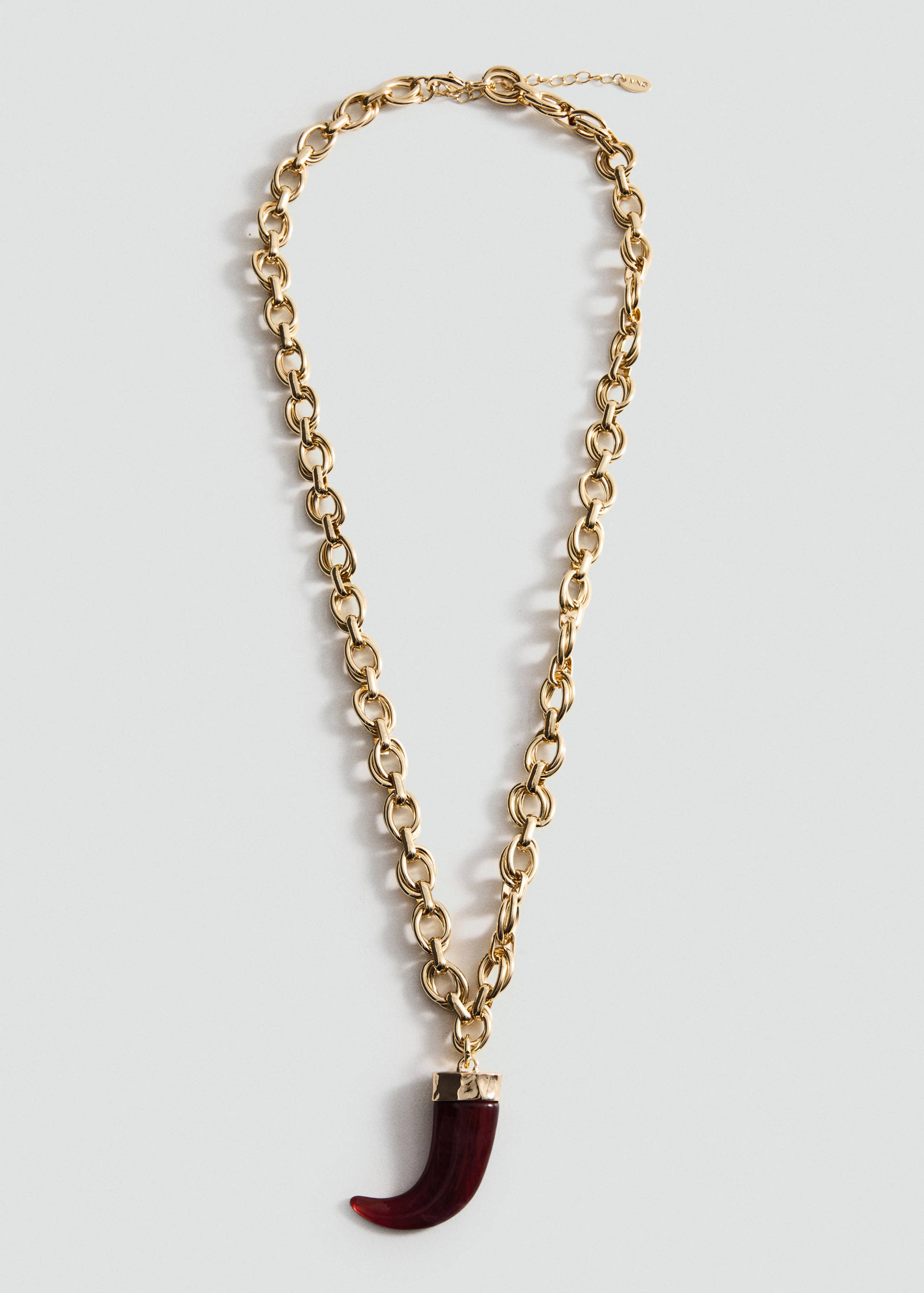 Gold chain necklace with a curved burgundy resin horn pendant.