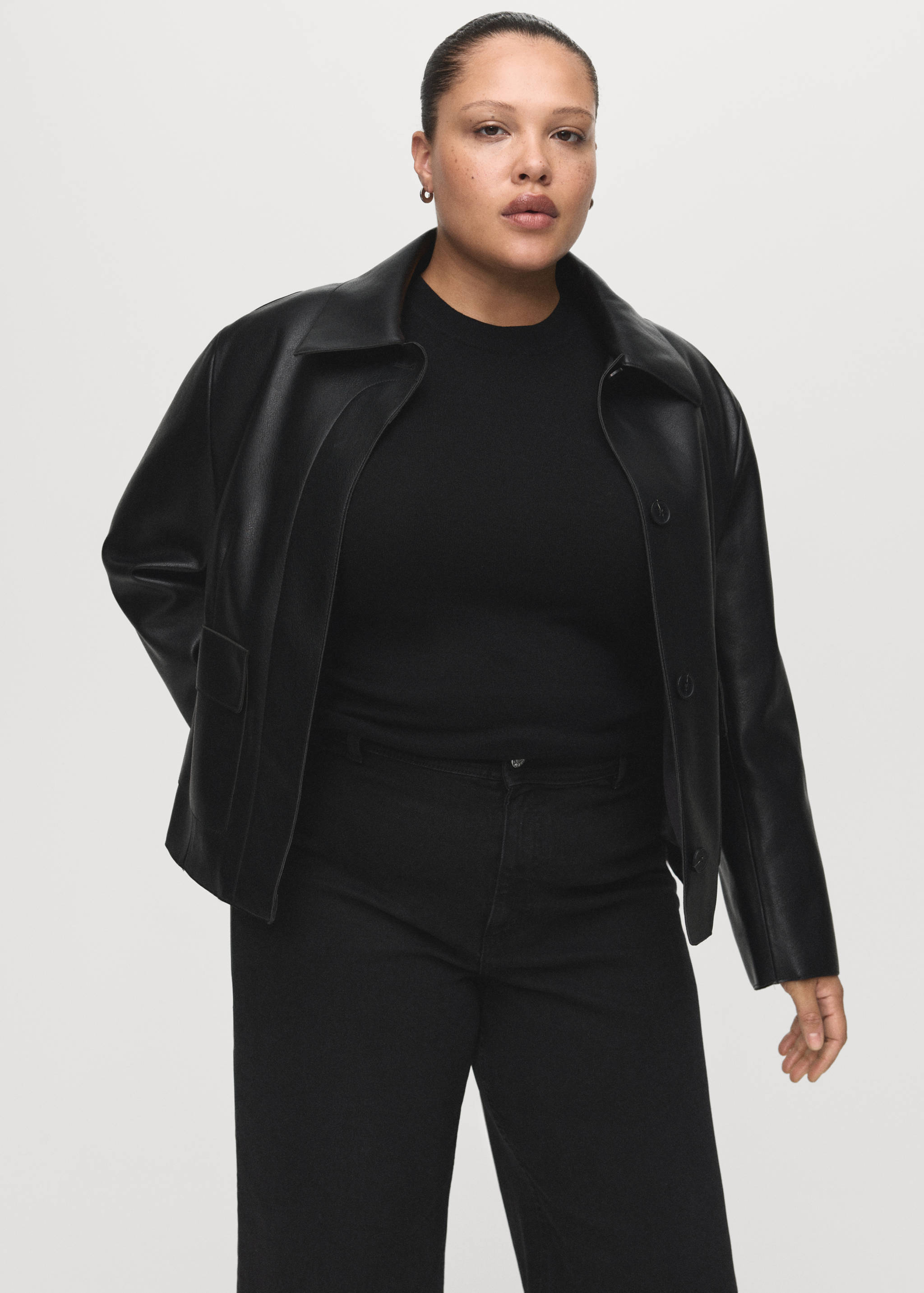 Black denim jacket with a classic collar and front button closure.