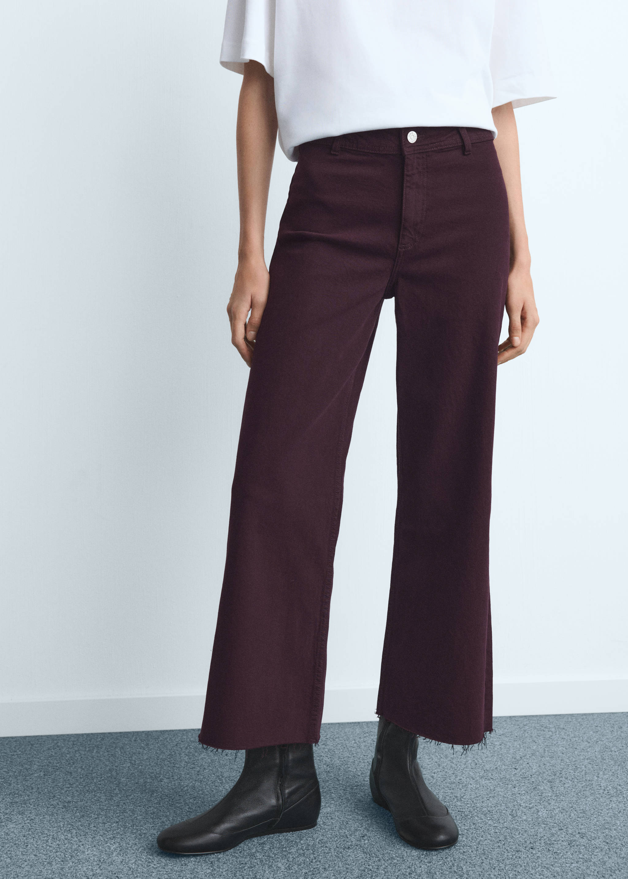 Dark purple cropped straight-leg denim trousers with frayed raw hems.