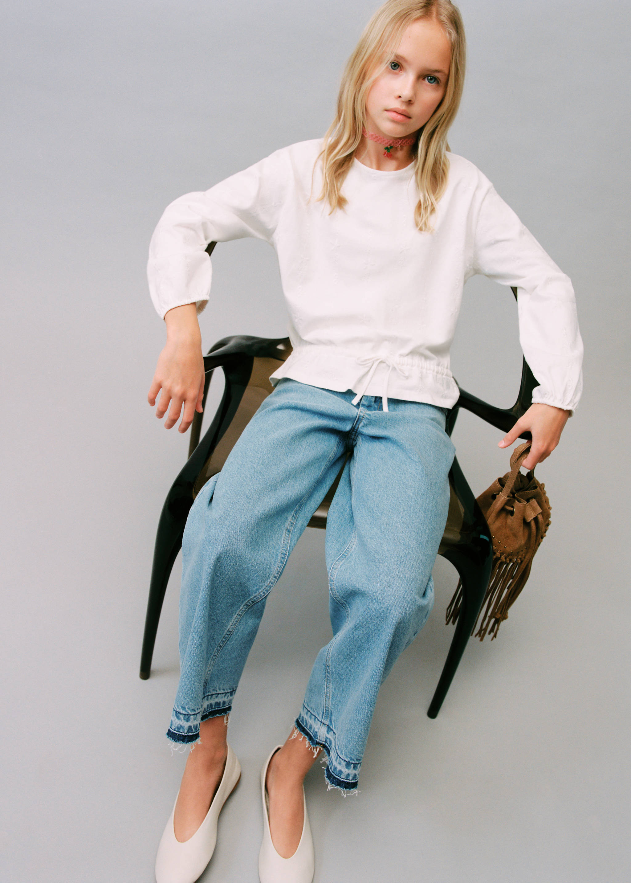 Light blue denim culotte jeans with frayed cropped hems, worn with a white blouse.