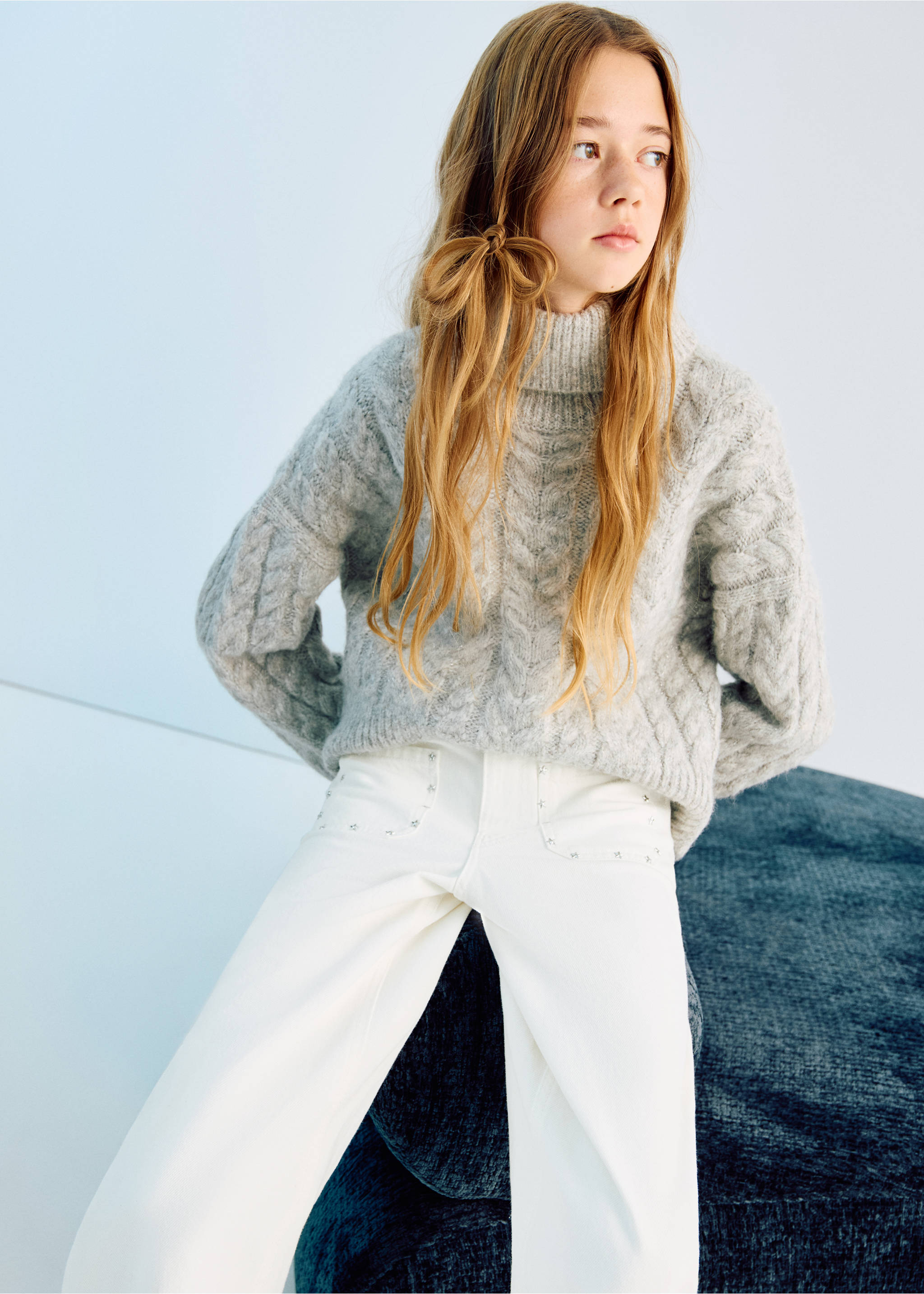 White culotte trousers with stud-trimmed pockets, worn with a grey cable-knit sweater., White. Ref: 27011263-00.