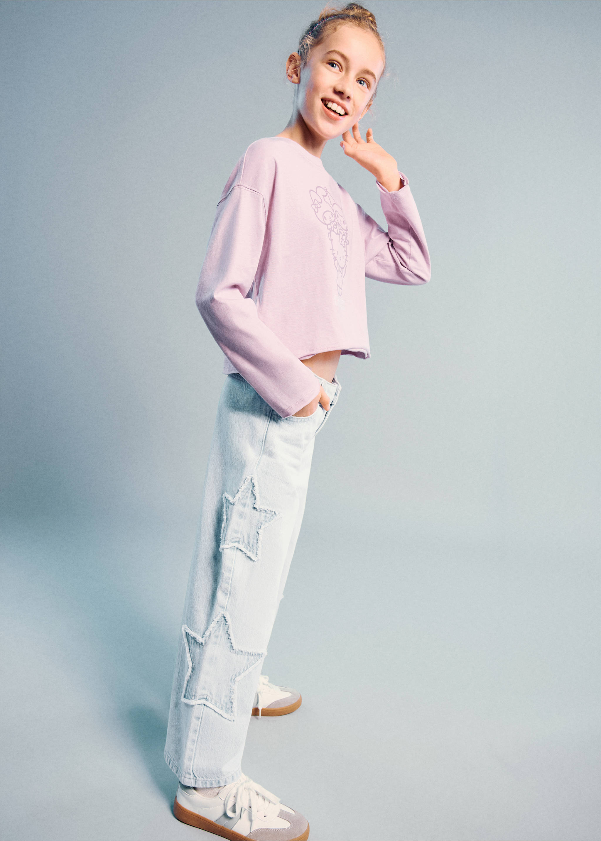 Light-wash denim trousers with frayed star patches, worn with a purple t-shirt., Light Blue. Ref: 27011264-00.