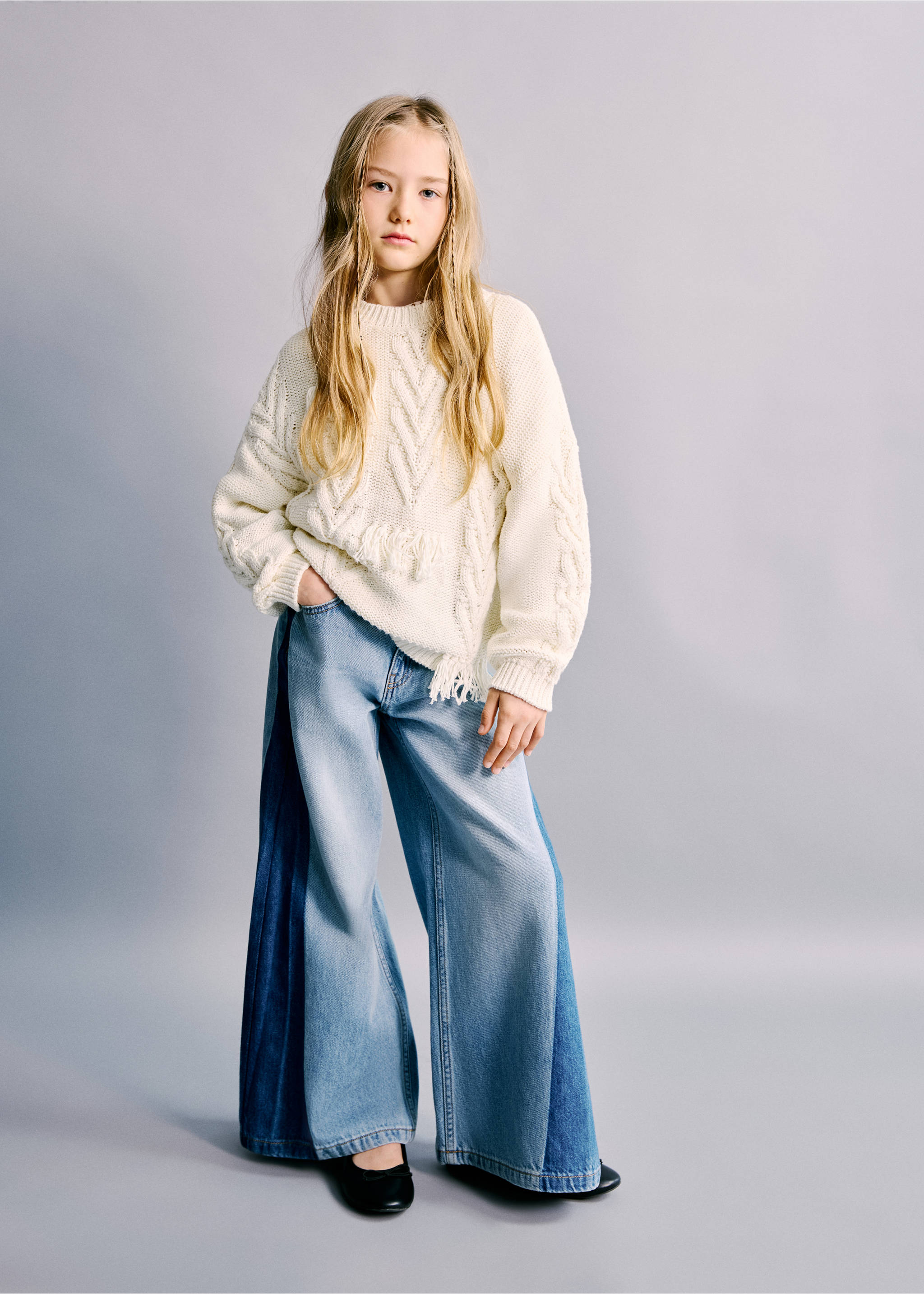 Light blue wide-leg denim trousers with contrast dark side panels, styled with a cream cable-knit sweater., Medium Blue. Ref: 27012893-00.