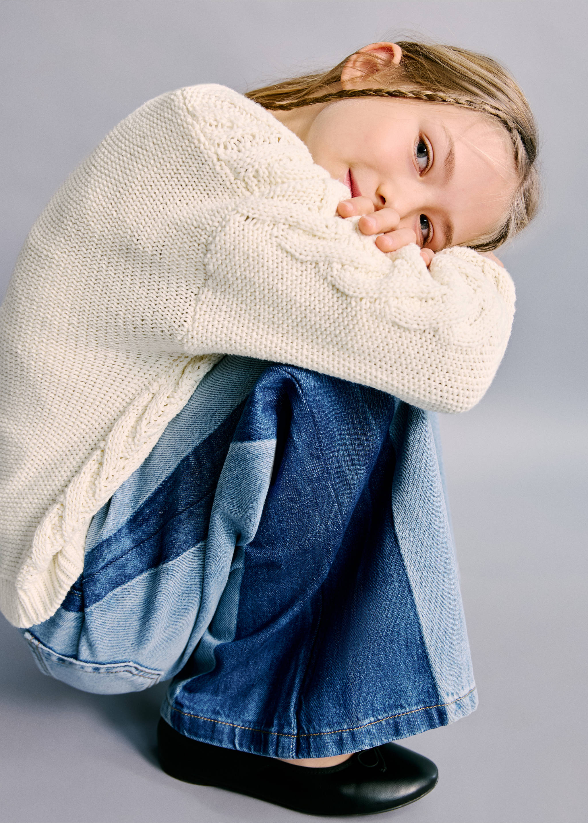 Blue panelled denim trousers paired with a cream cable-knit jumper., Medium Blue. Ref: 27012893-00.