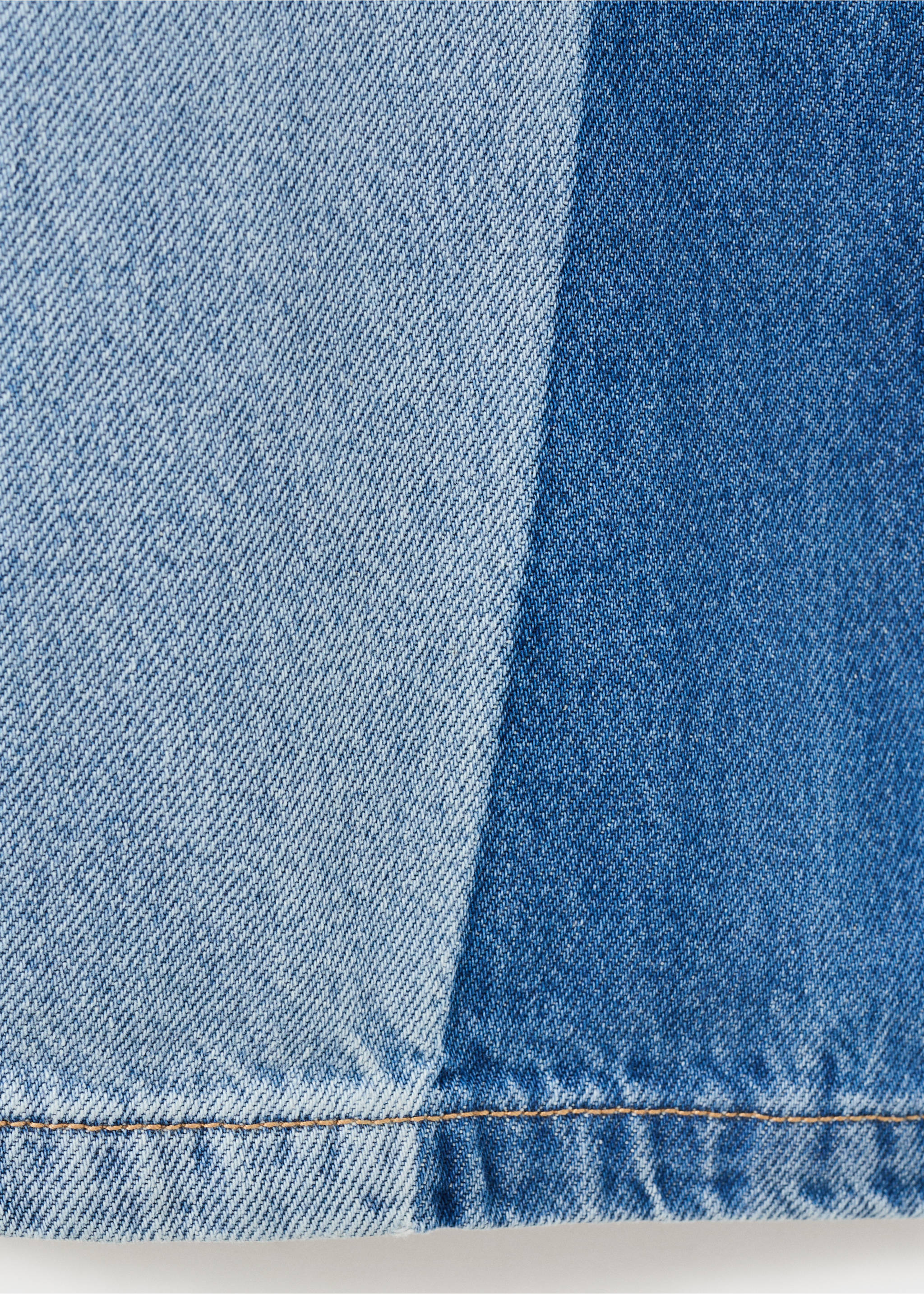 Close-up of a two-tone denim garment with contrasting blue panels., Medium Blue. Ref: 27012893-00.