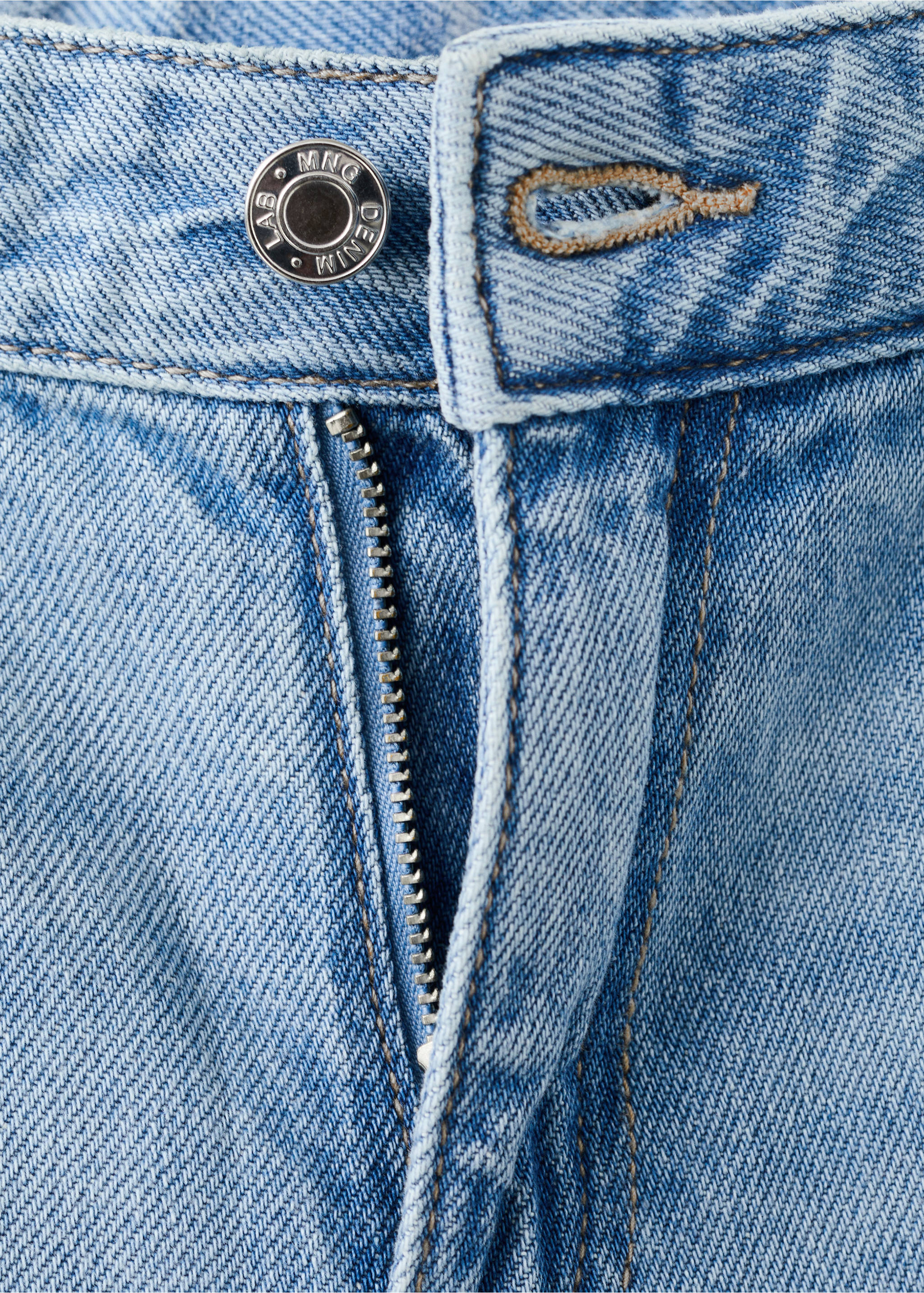 Close-up of light blue denim trousers showing the button and zip closure., Medium Blue. Ref: 27012893-00.