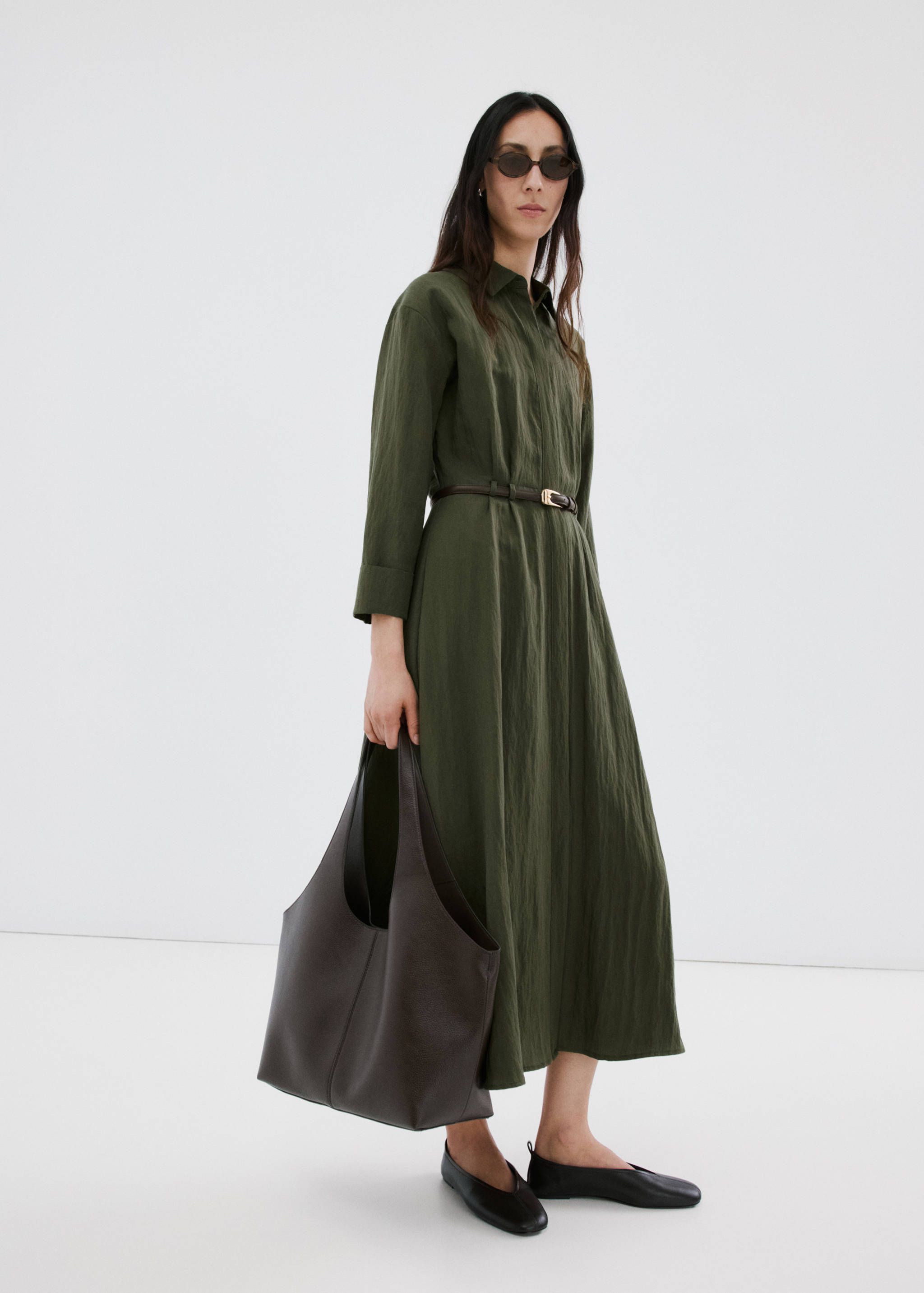 Olive green midi shirt dress with a thin brown belt, worn by a model.