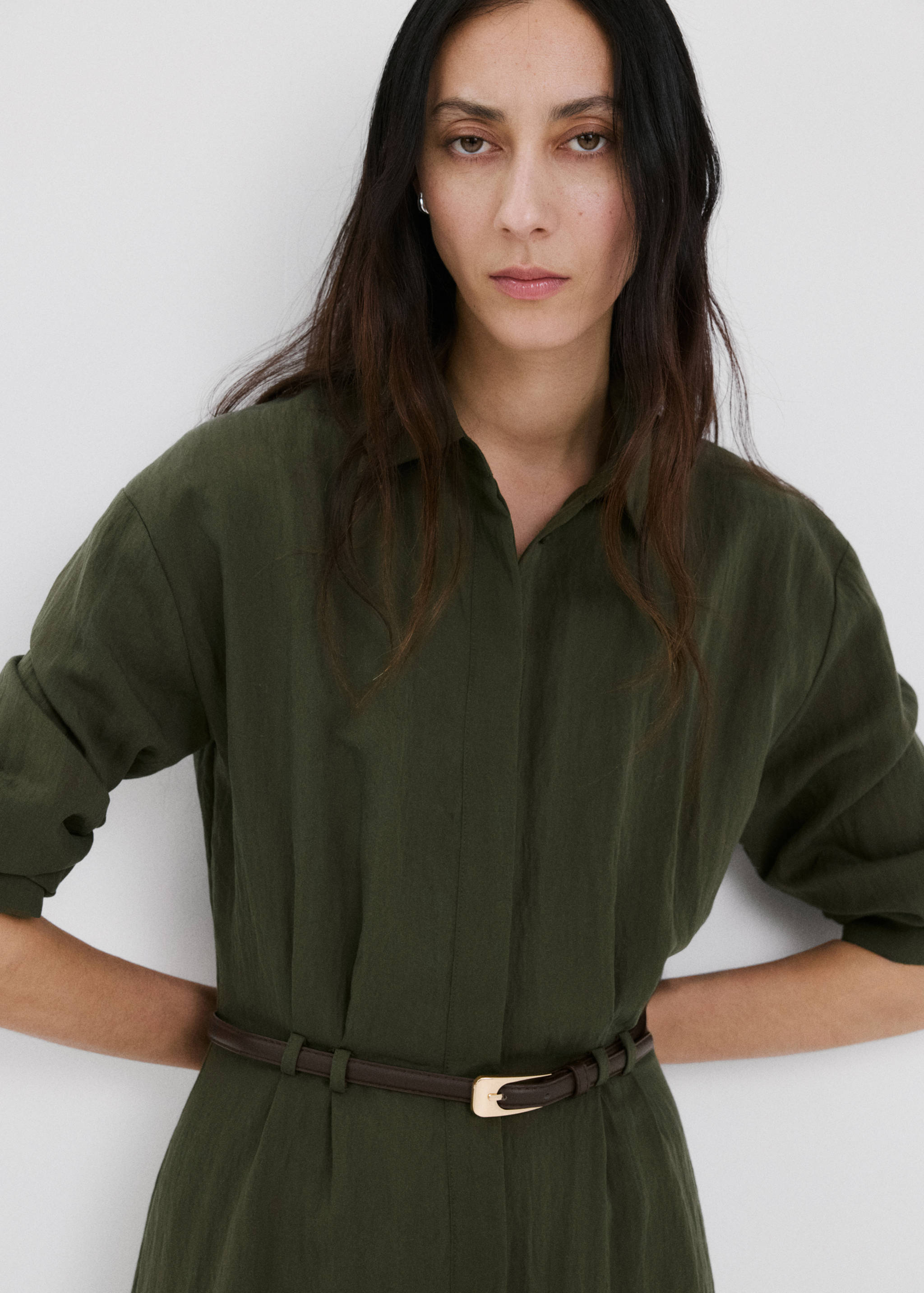 Dark khaki green shirt dress with collar, long sleeves and a thin brown belt.