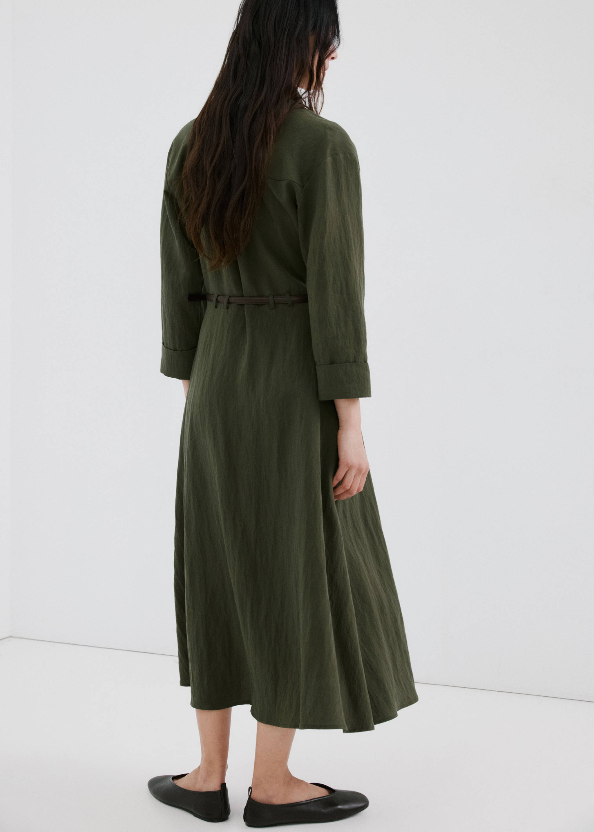 Dark khaki green midi shirt dress with long sleeves and a slim belt, back view.