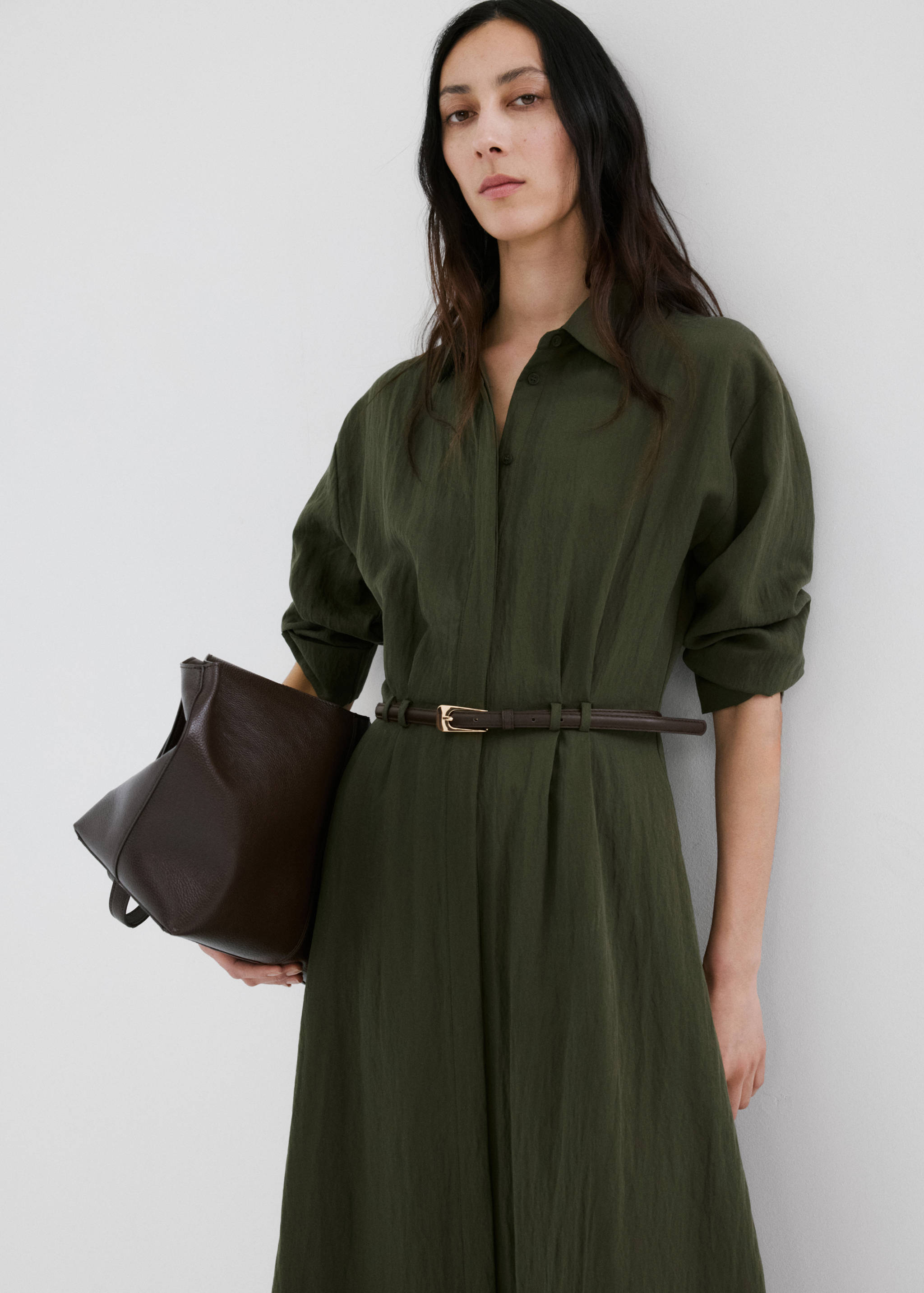 Olive green shirt dress with a thin brown belt and gold buckle, shown in a close-up e-commerce view.