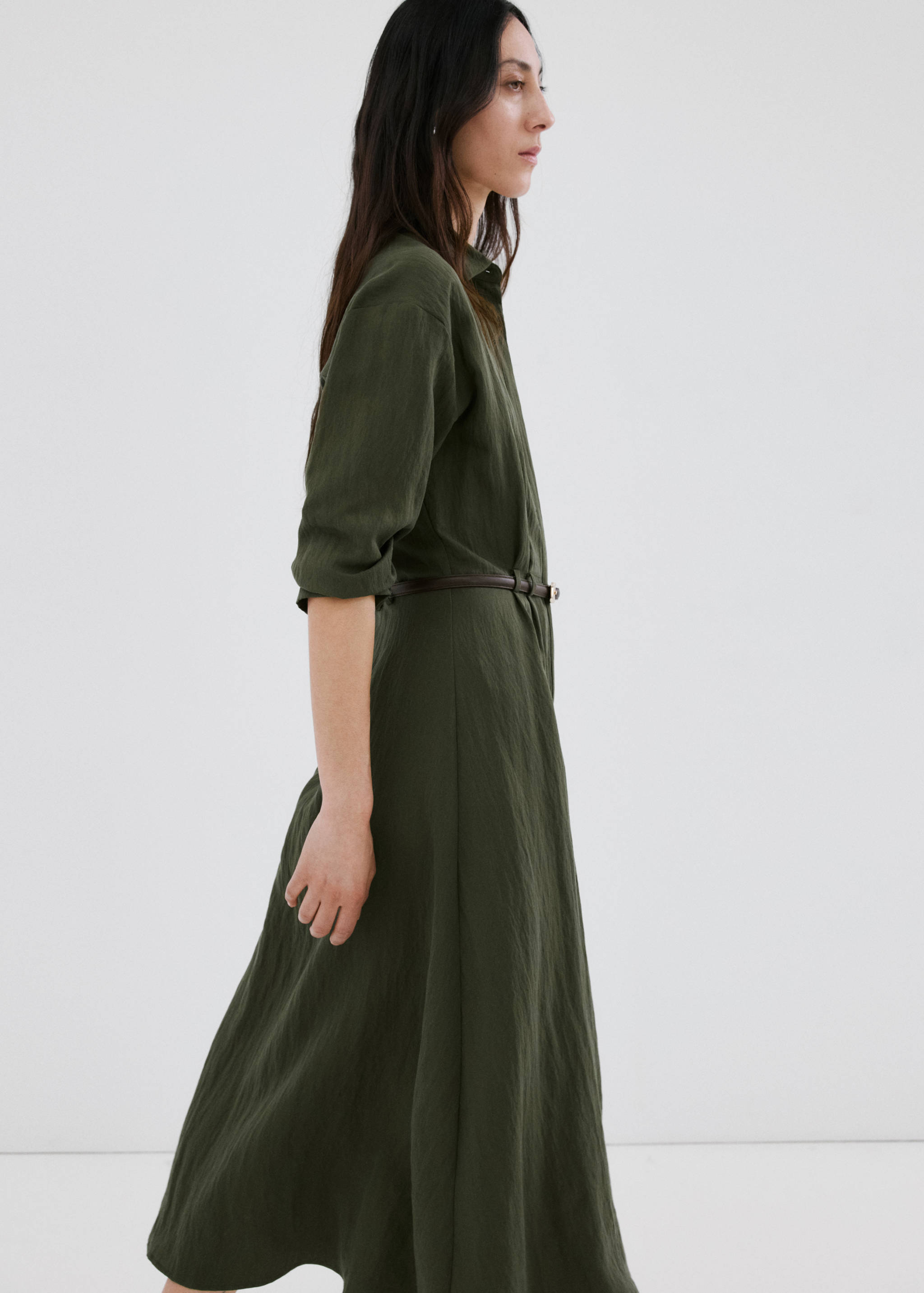 Dark green shirt dress with long sleeves and a thin brown belt