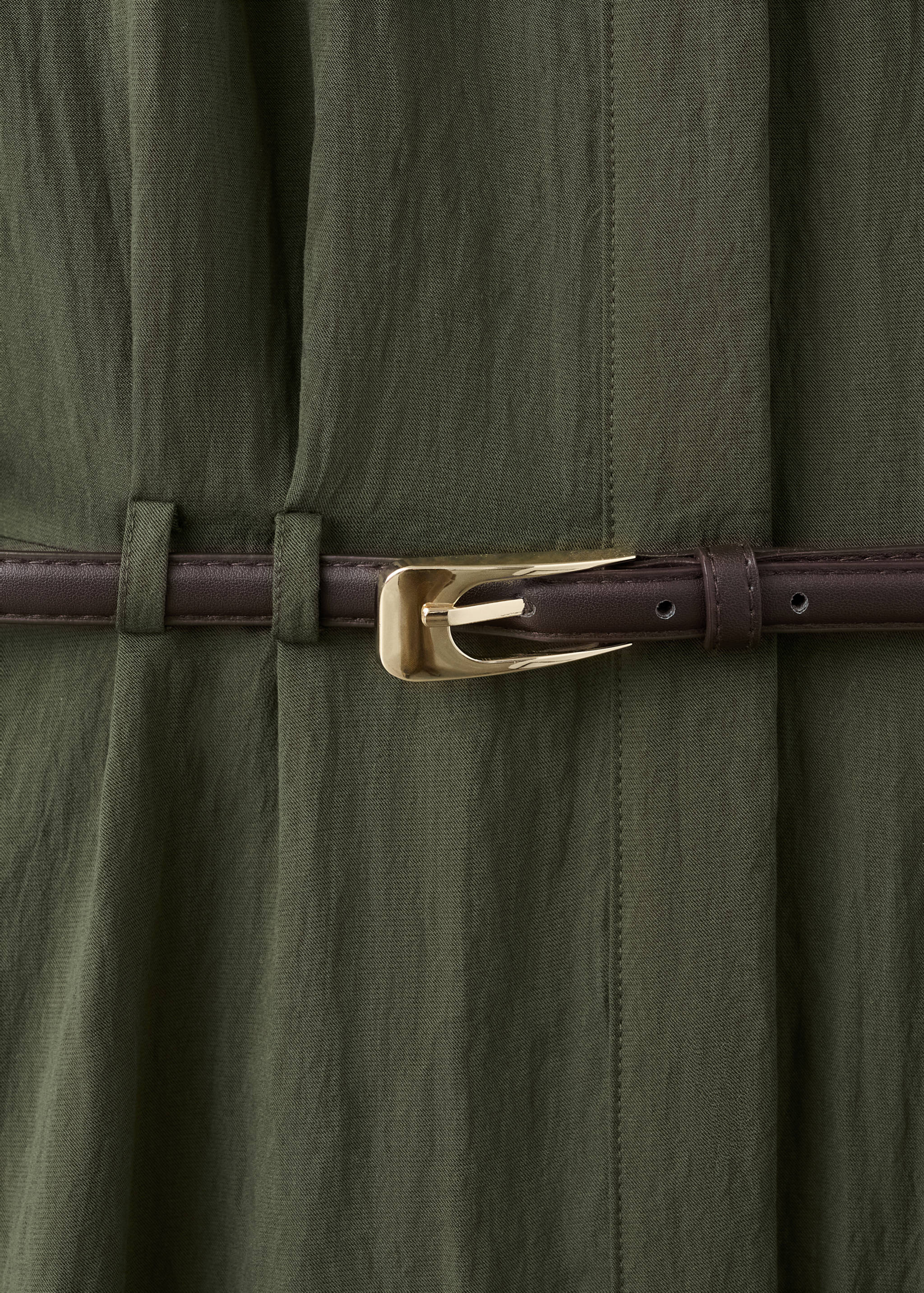 Close-up of an olive green dress with a dark brown belt and gold buckle.