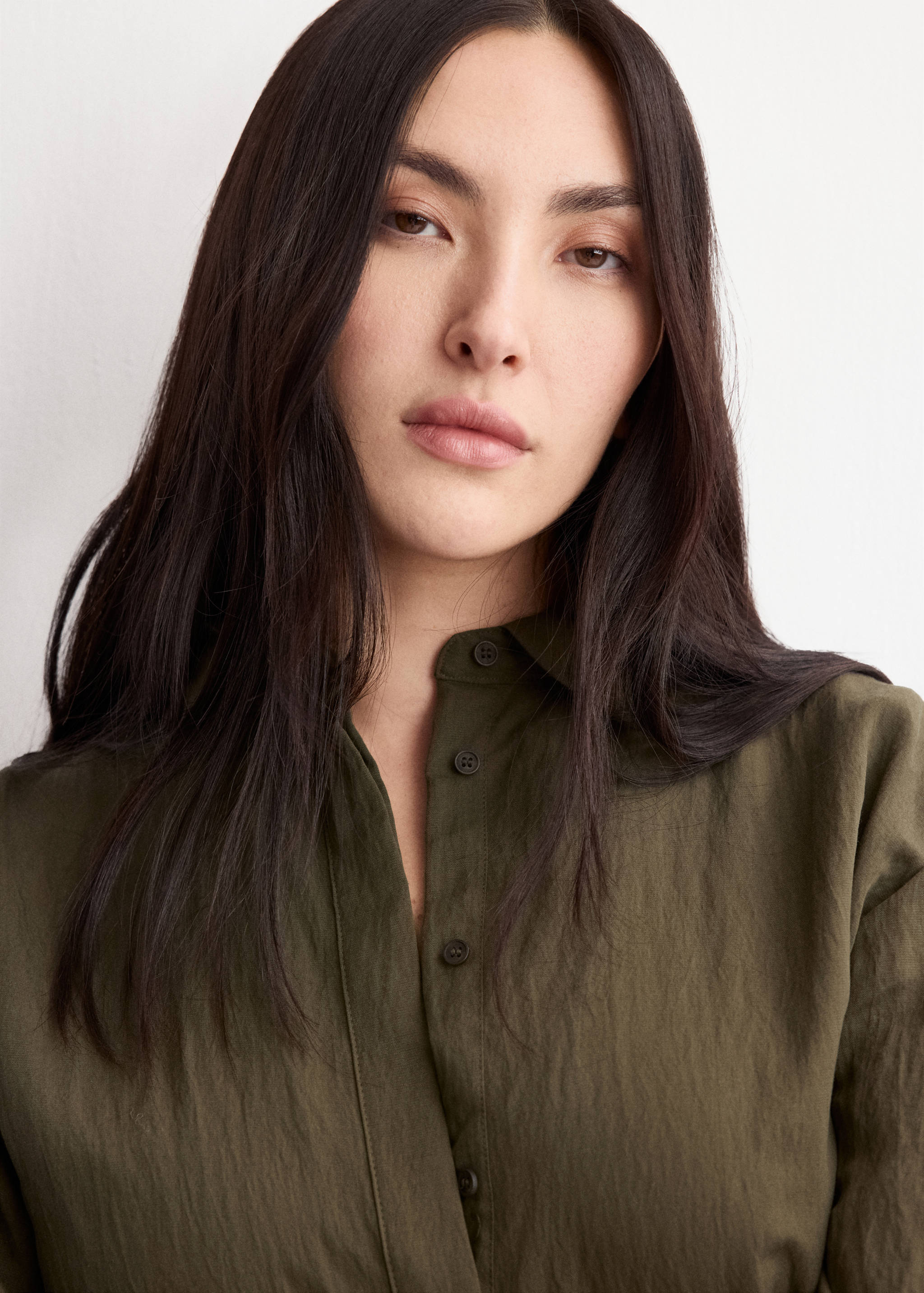 Olive green dress featuring a classic shirt collar and front button placket.