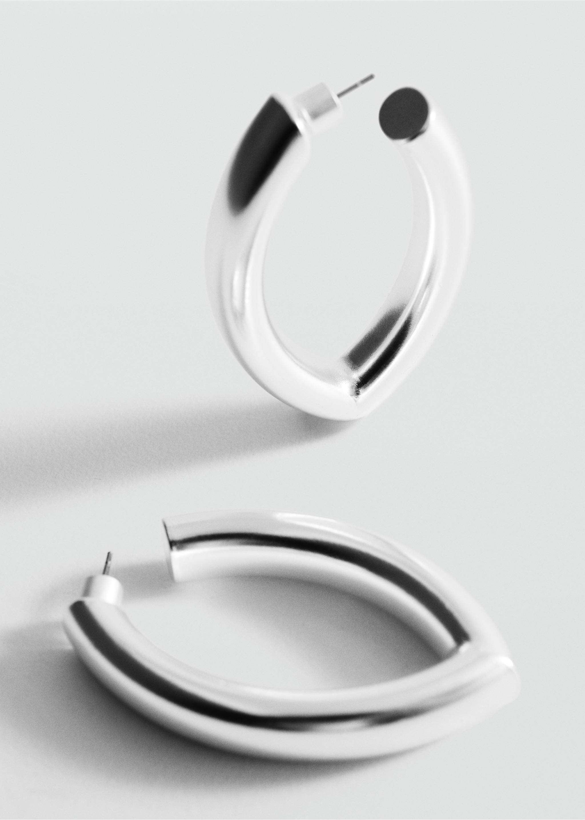 Chunky silver-toned hoop earrings with a polished, thick oval profile., Silver. Ref: 27017798-00.