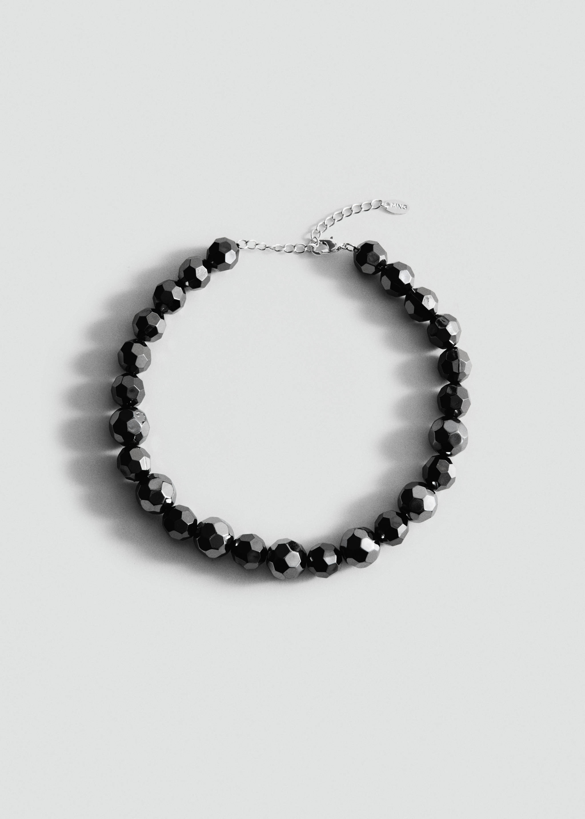 Black faceted bead collar necklace with an adjustable silver chain.