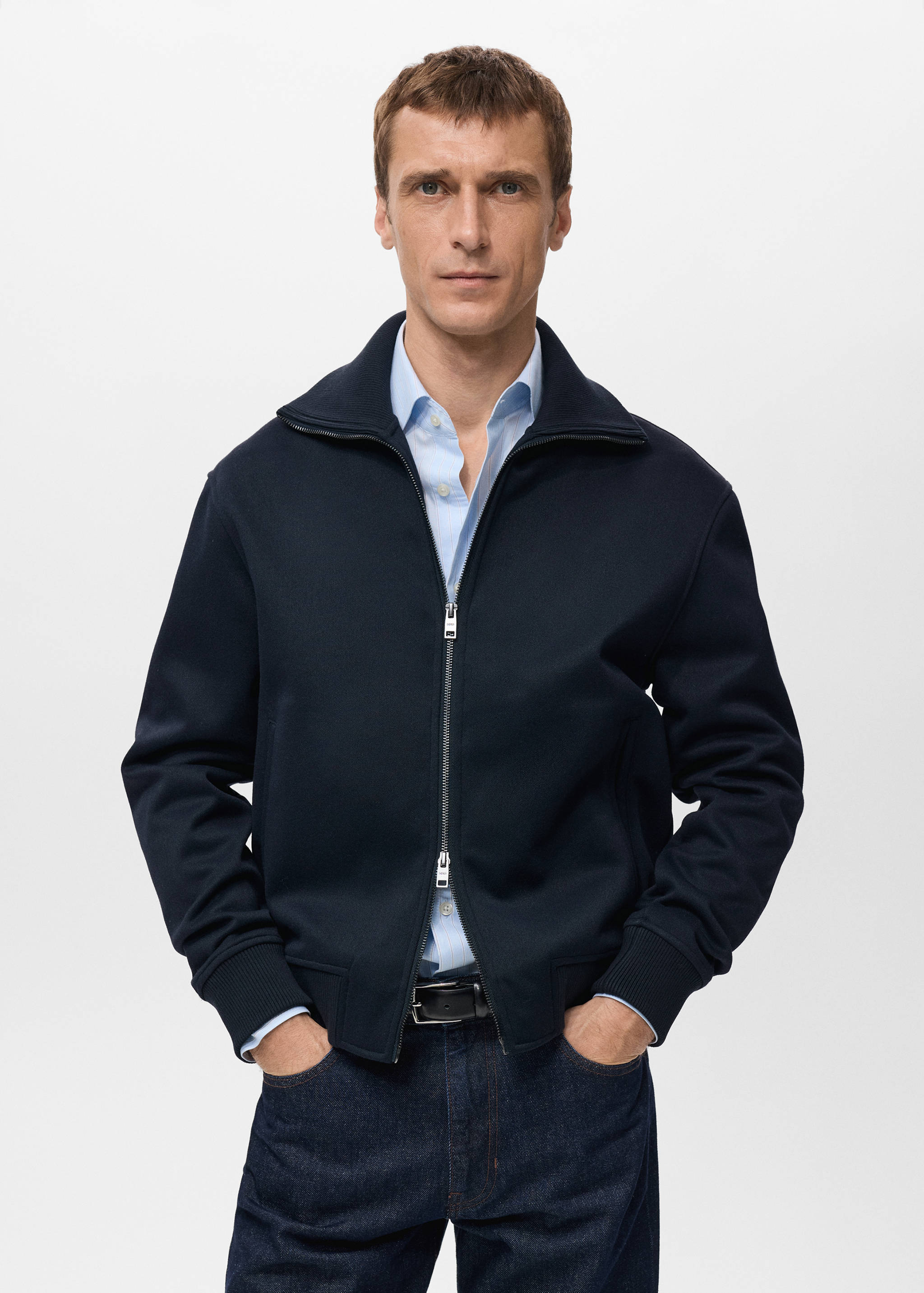 Navy blue zip-up sweatshirt with a high collar and ribbed hems.