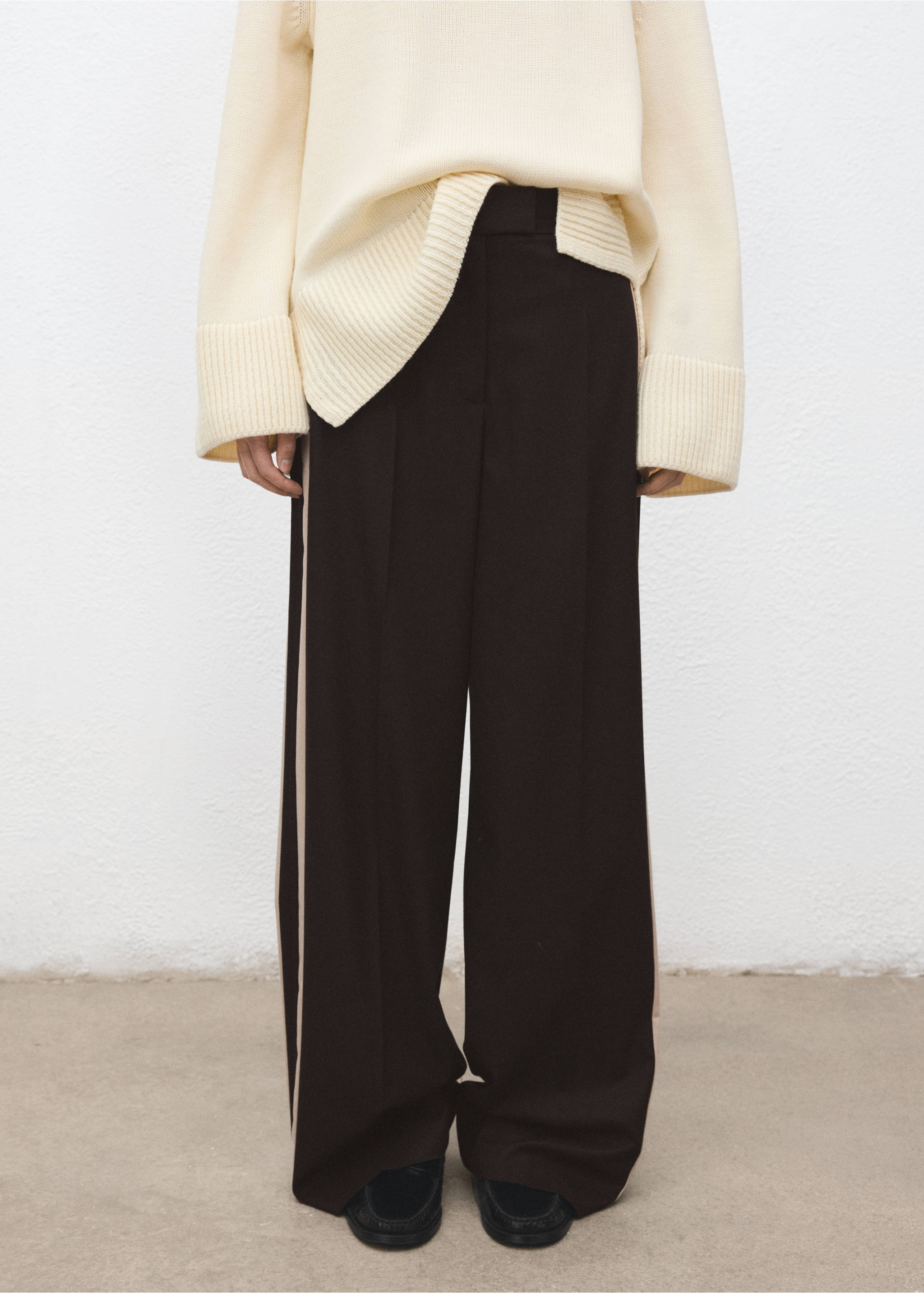 Dark brown wide-leg trousers with cream side stripes, worn with an oversized cream knit sweater., Chocolate. Ref: 27021296-00.