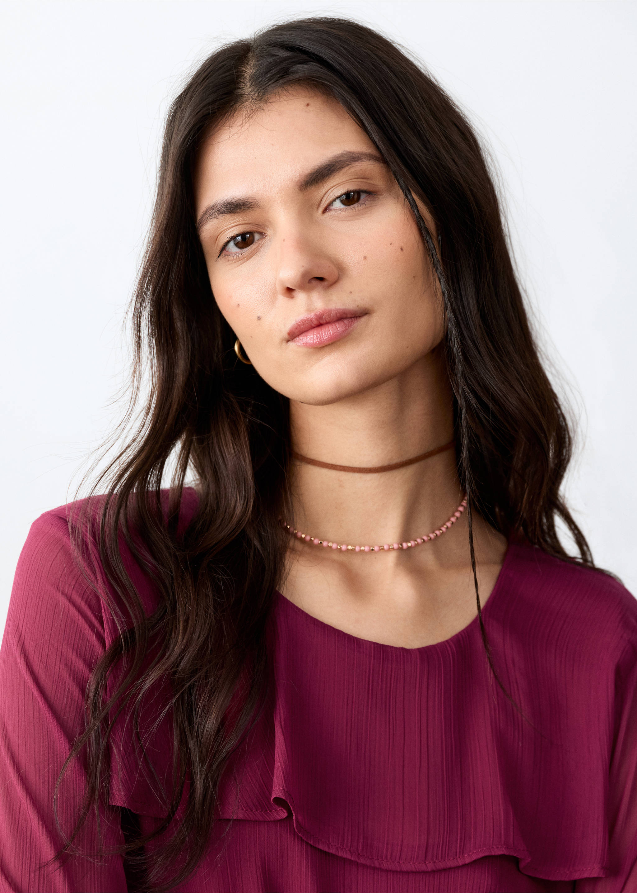 Burgundy blouse with a ruffled overlay and round neckline in a close-up view., Purple. Ref: 27021541-00.