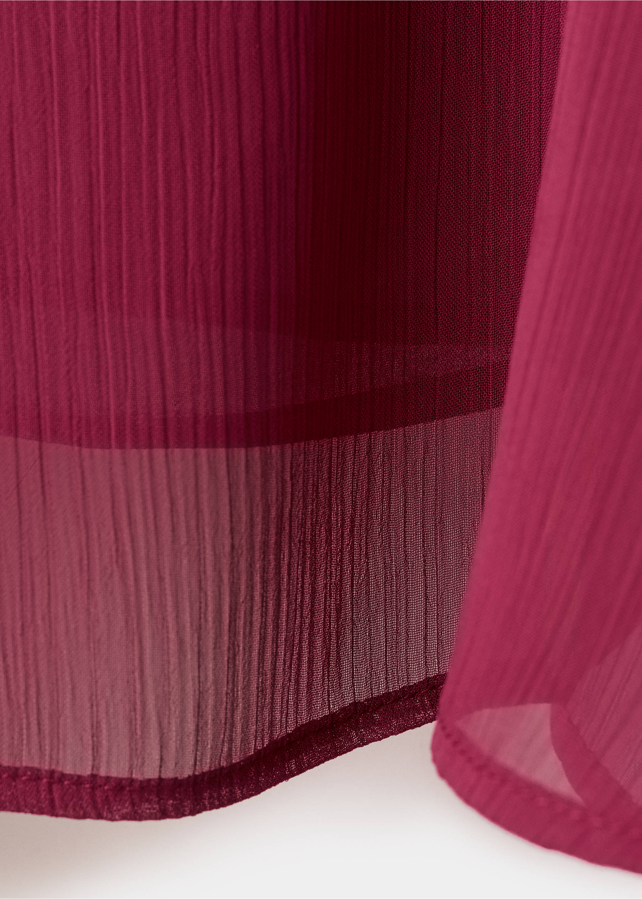 Close-up of the pleated texture and hem of a magenta blouse., Purple. Ref: 27021541-00.