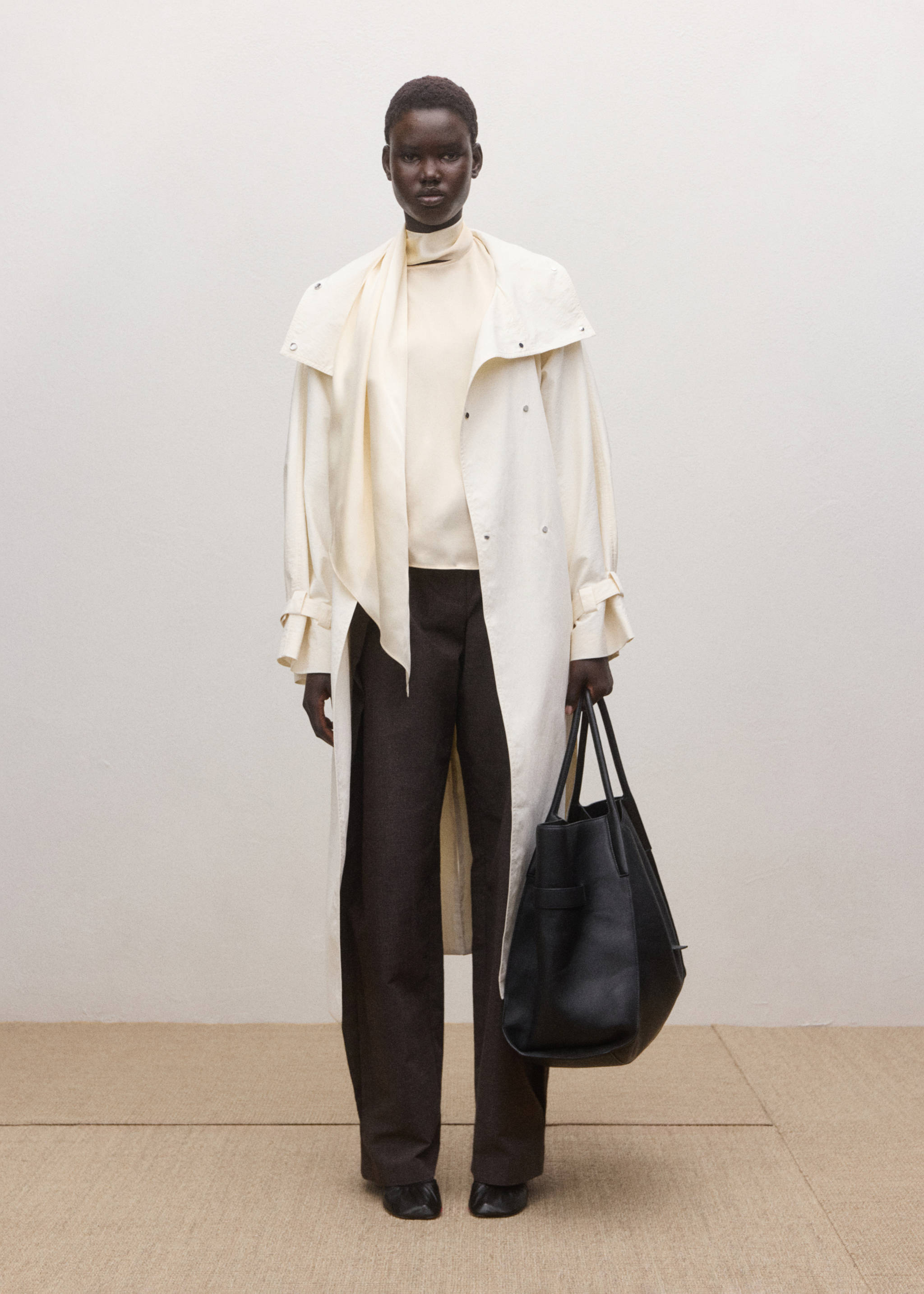 Ivory blouse with a high neck and scarf detail, worn with a cream trench coat., Ecru. Ref: 27024097-00.