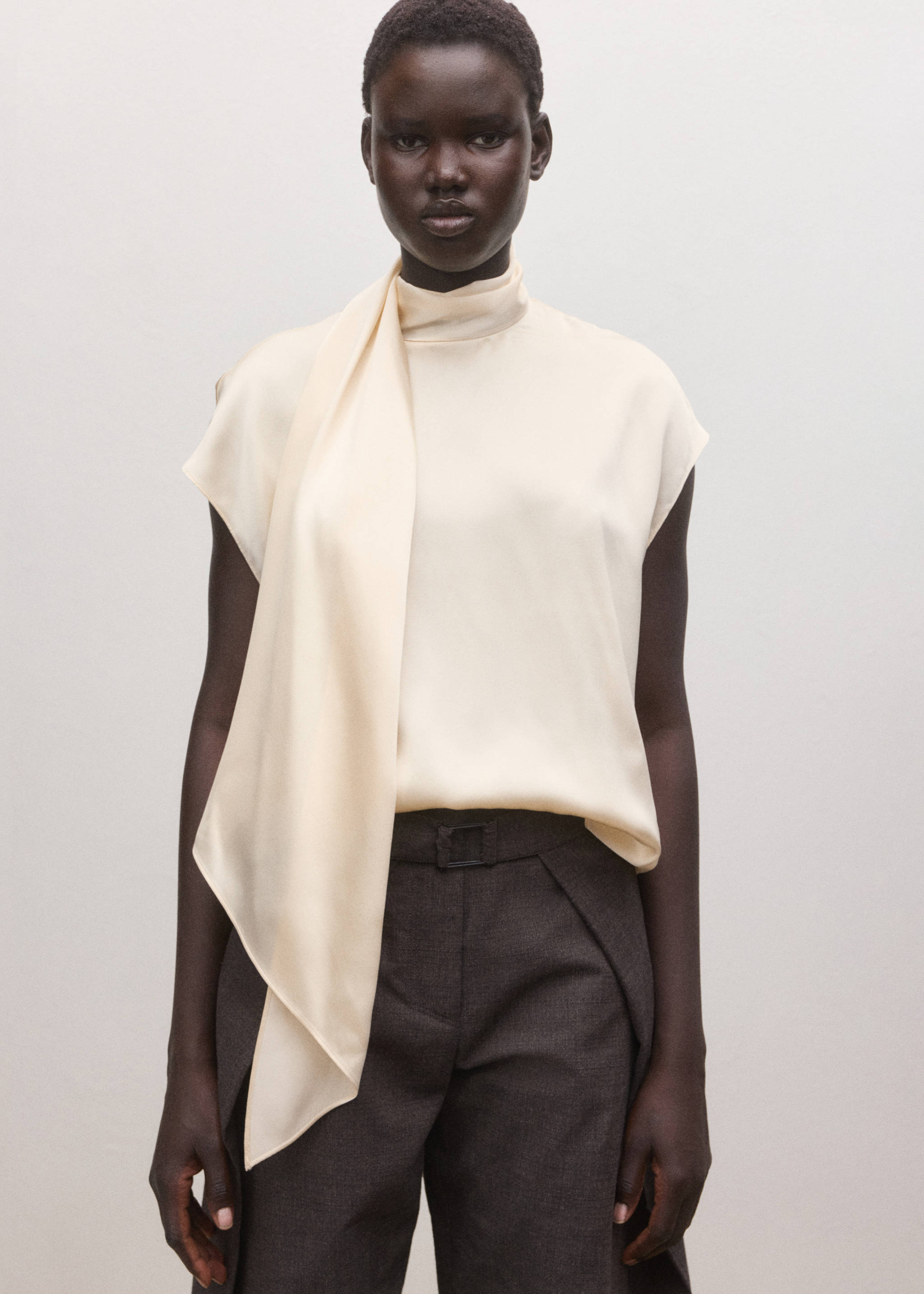 Cream sleeveless satin blouse with high funnel neck and draped scarf tie., Ecru. Ref: 27024097-00.