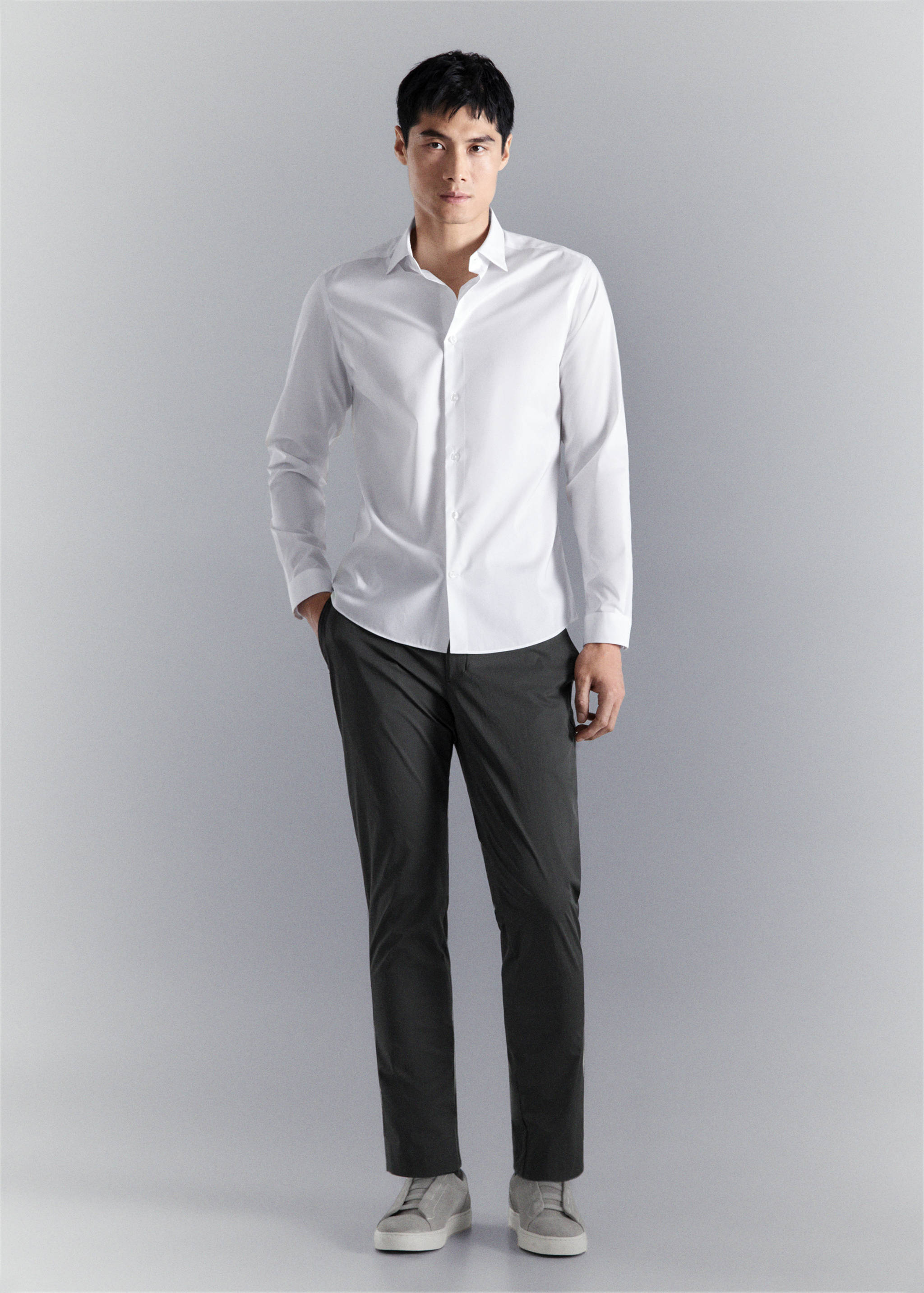 White long-sleeved shirt with a classic collar and button fastening.