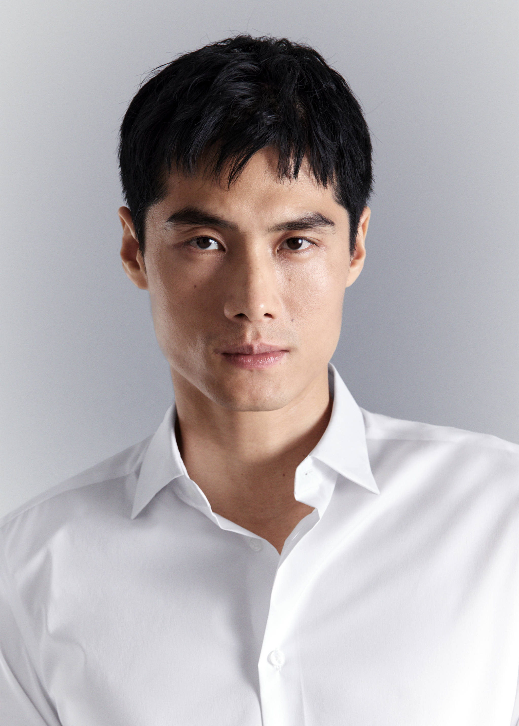 Close-up of a white shirt with a classic pointed collar.