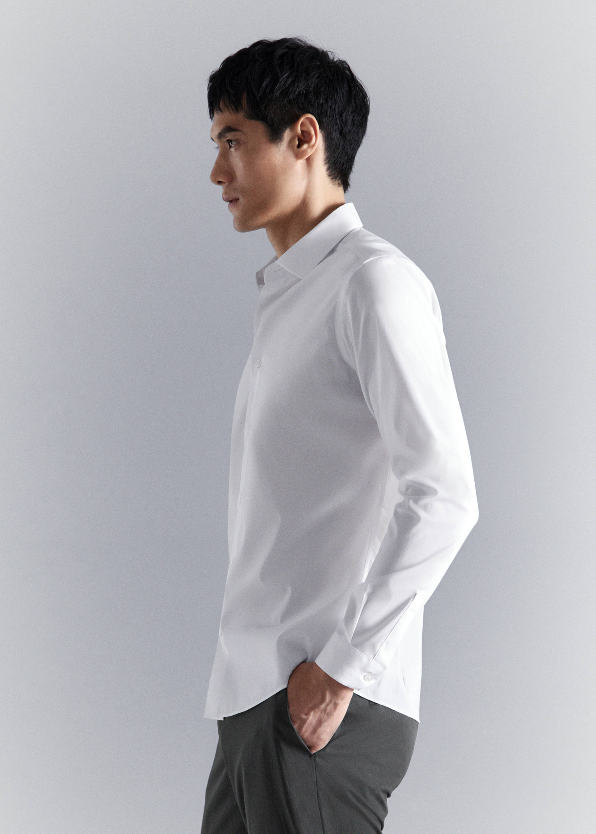 White long-sleeved shirt with a classic collar and buttoned cuffs.