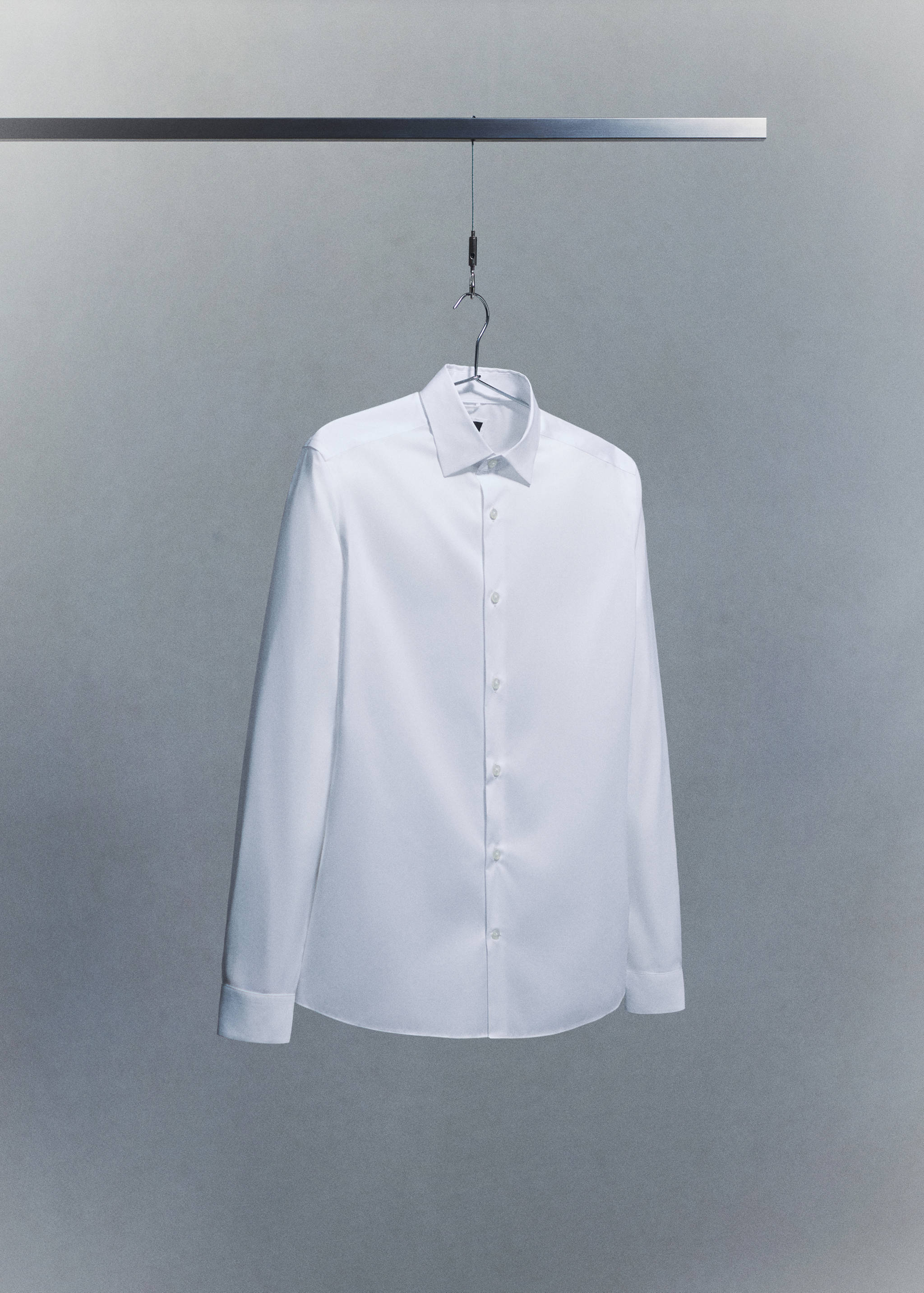 White long-sleeved shirt with a classic collar and button placket.