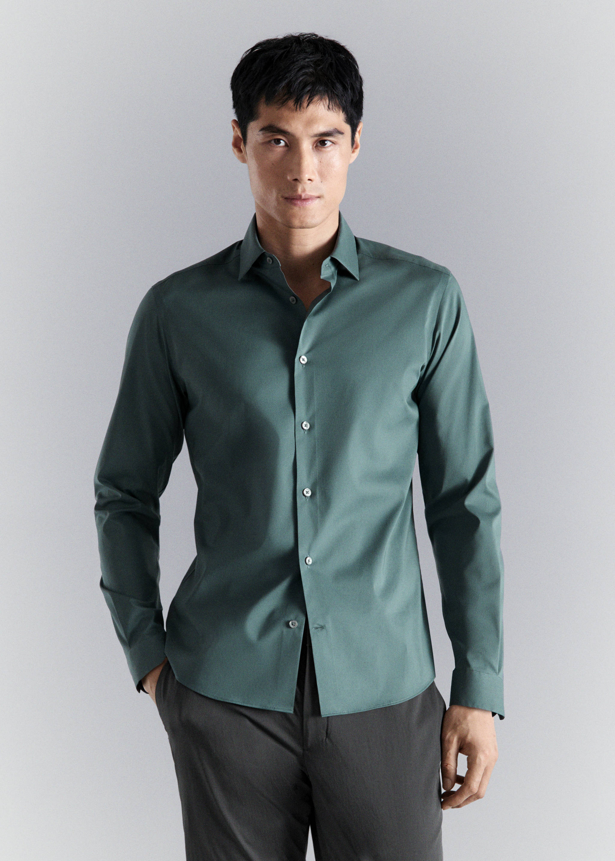 Dark green long-sleeved shirt with a classic collar.