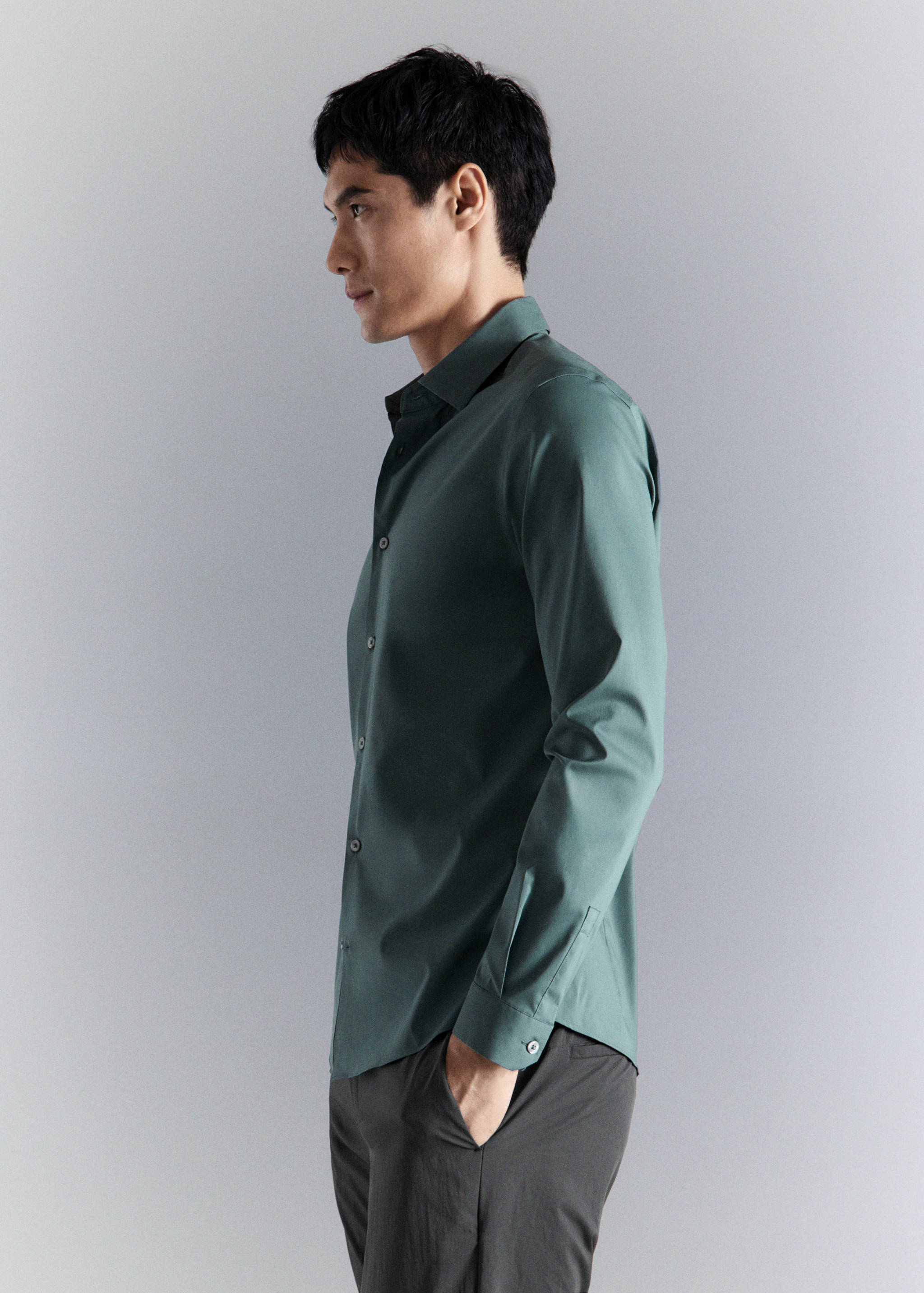 Dark green long-sleeved shirt with a classic collar and button-down front.