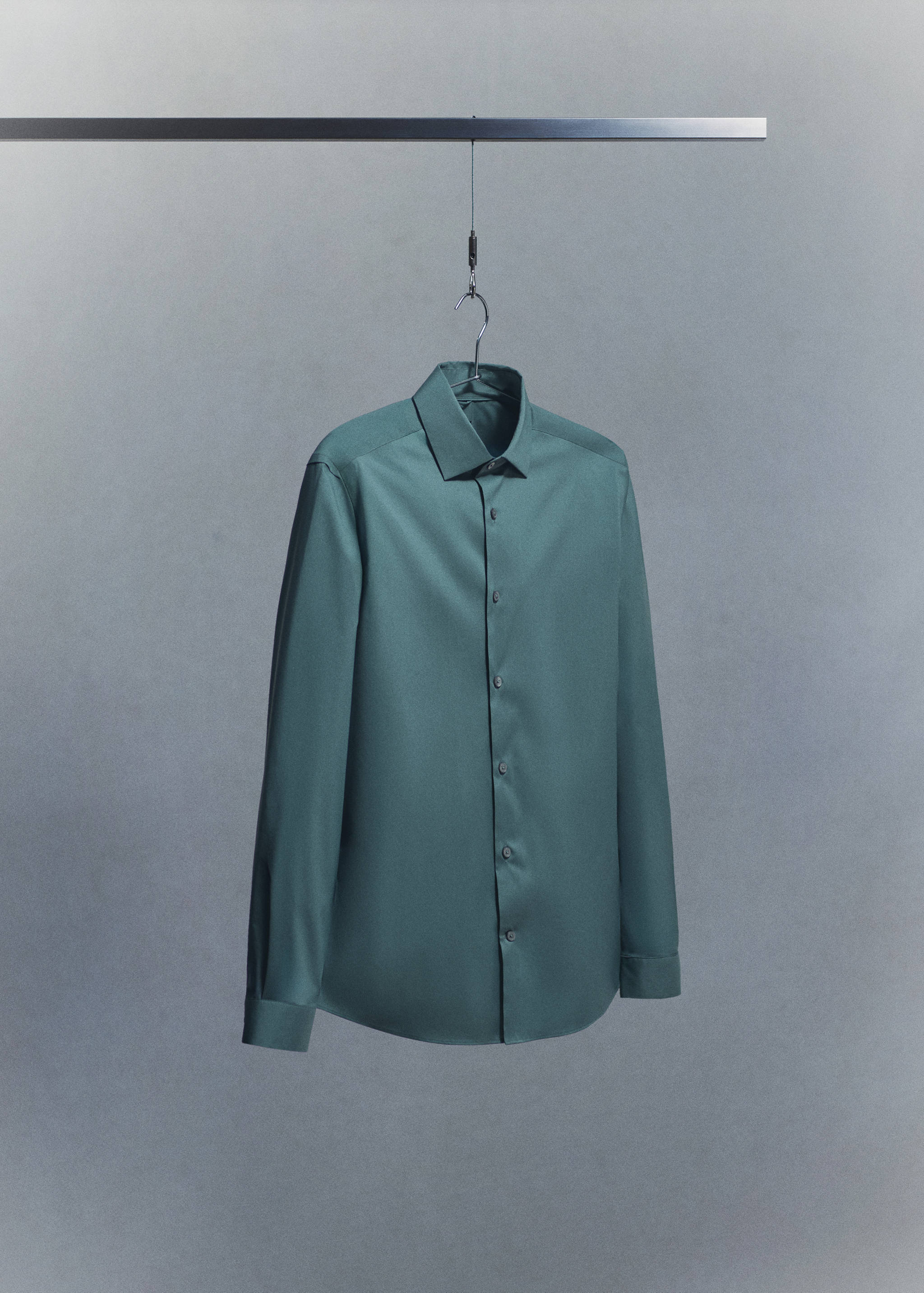 Green long-sleeve shirt with a classic collar and button placket.