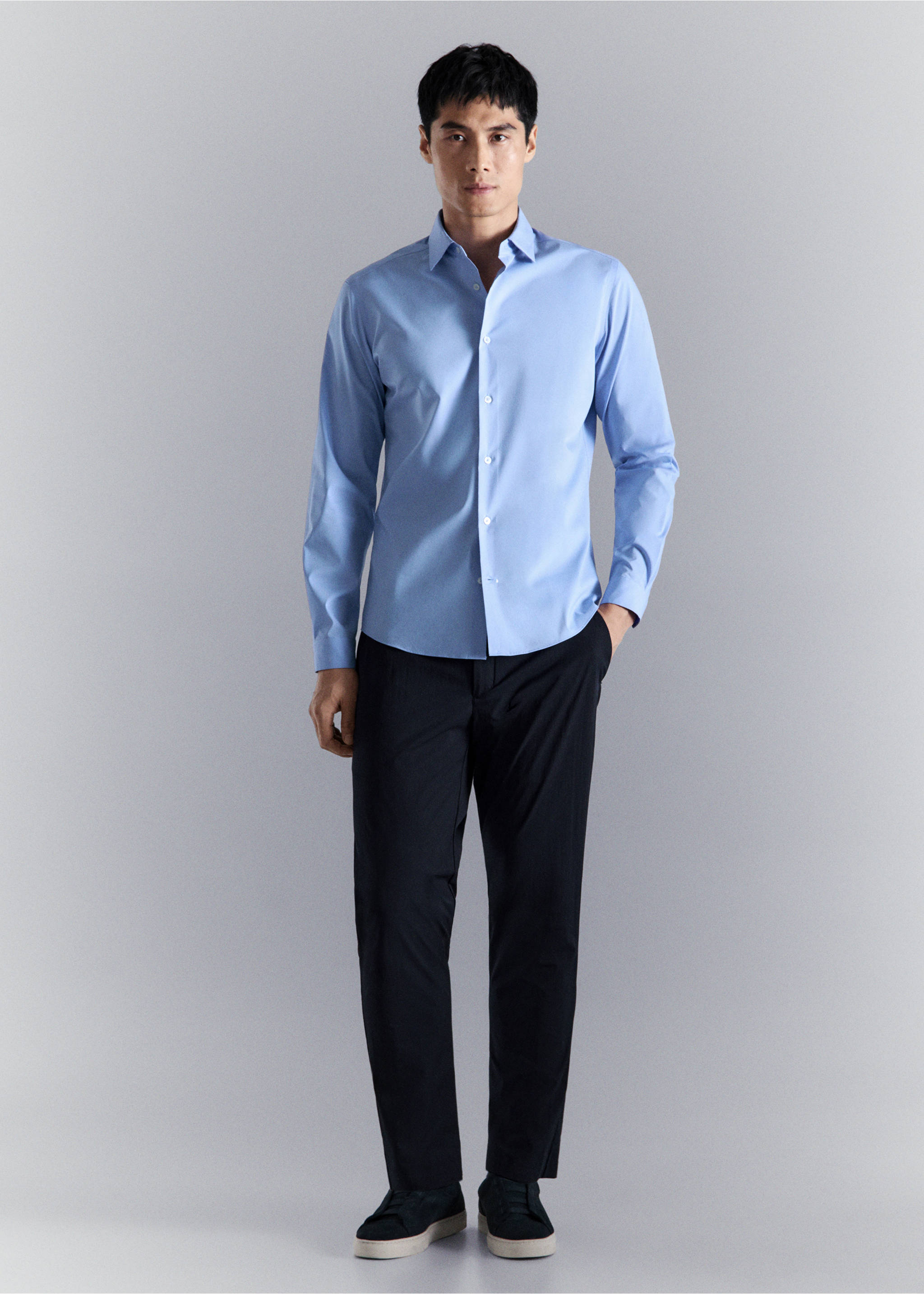 Light blue long-sleeved button-up shirt worn with dark trousers., China Blue. Ref: 27024424-00.