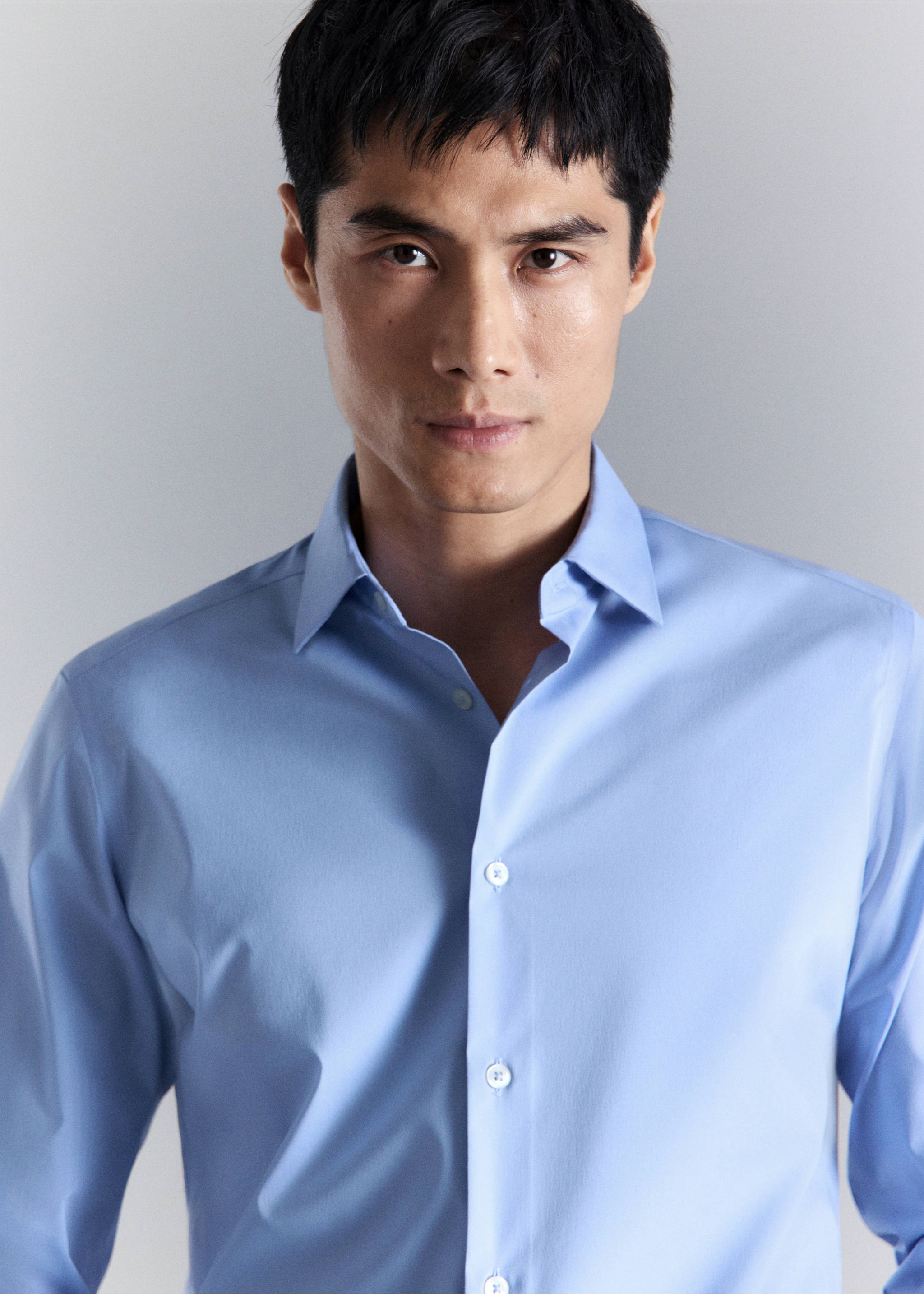 Close-up of a light blue shirt with a classic collar and buttons., China Blue. Ref: 27024424-00.