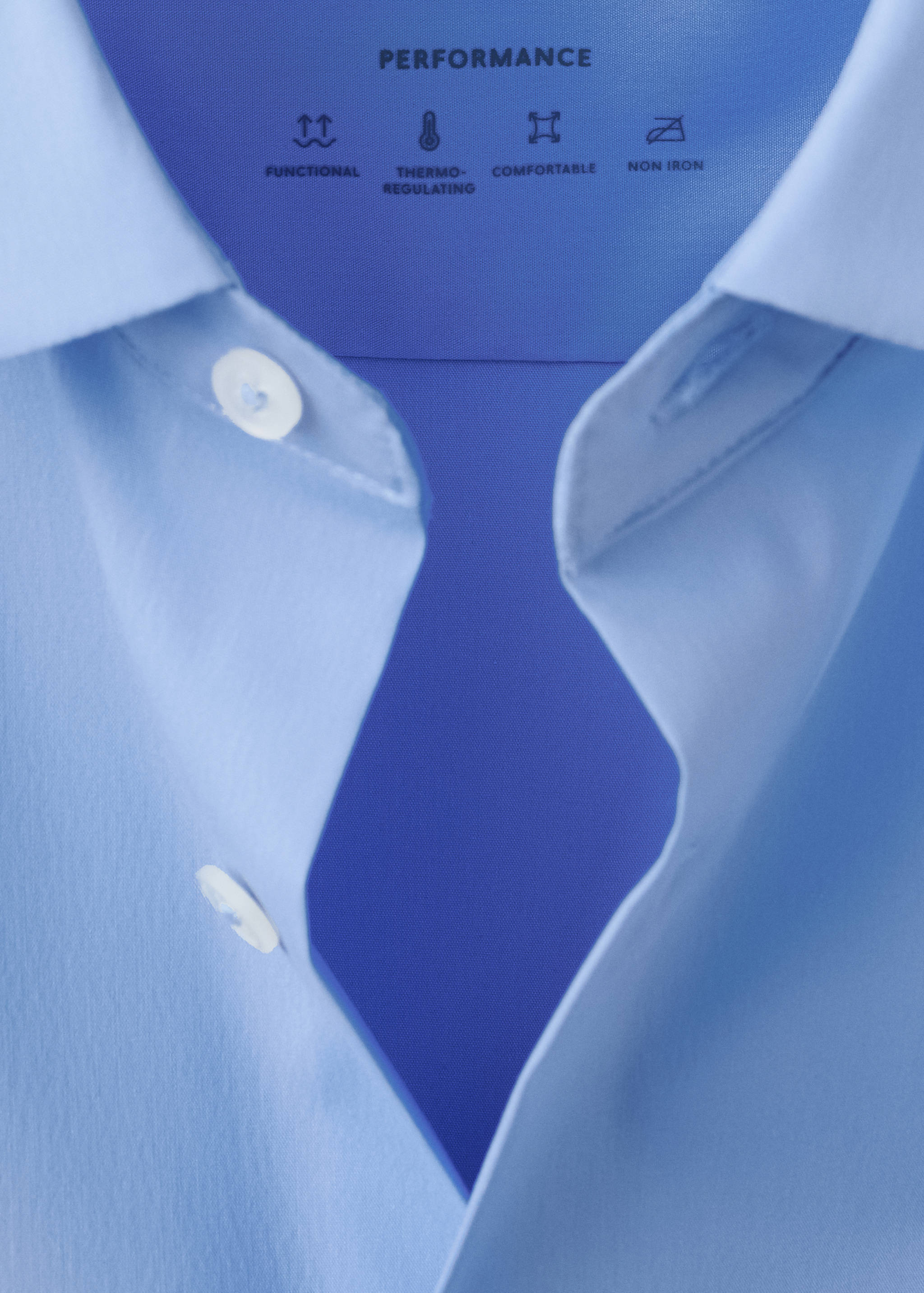 Close-up of a light blue men's shirt collar and performance details.