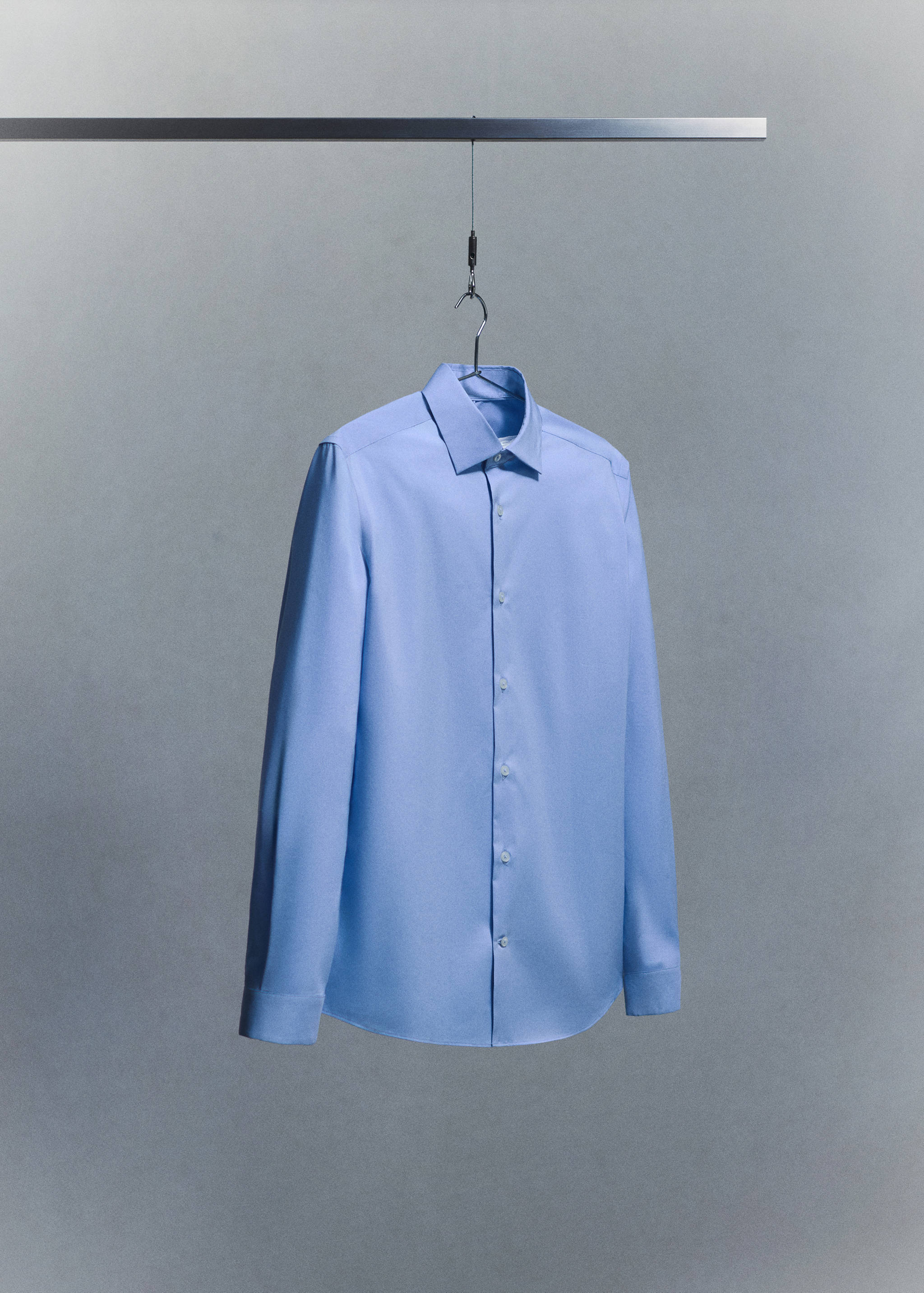 Light blue long-sleeve shirt with a point collar and button placket.