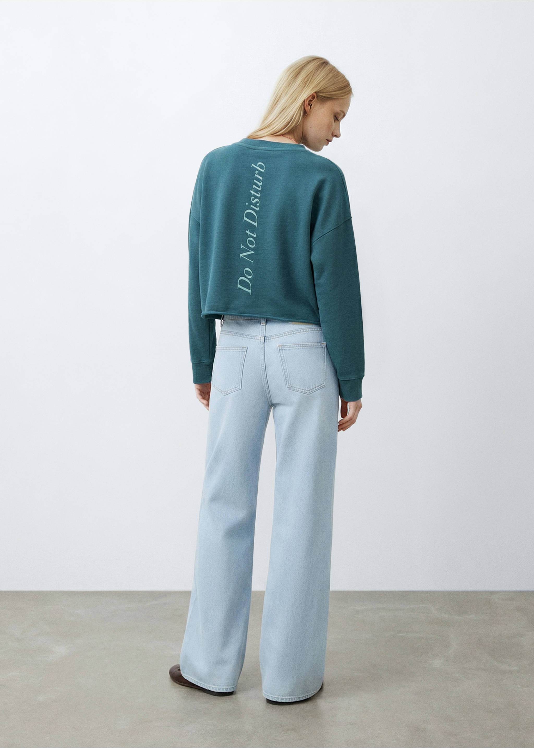 Teal sweatshirt with a back print and light blue trousers, back view., Petrol Blue. Ref: 27024778-00.
