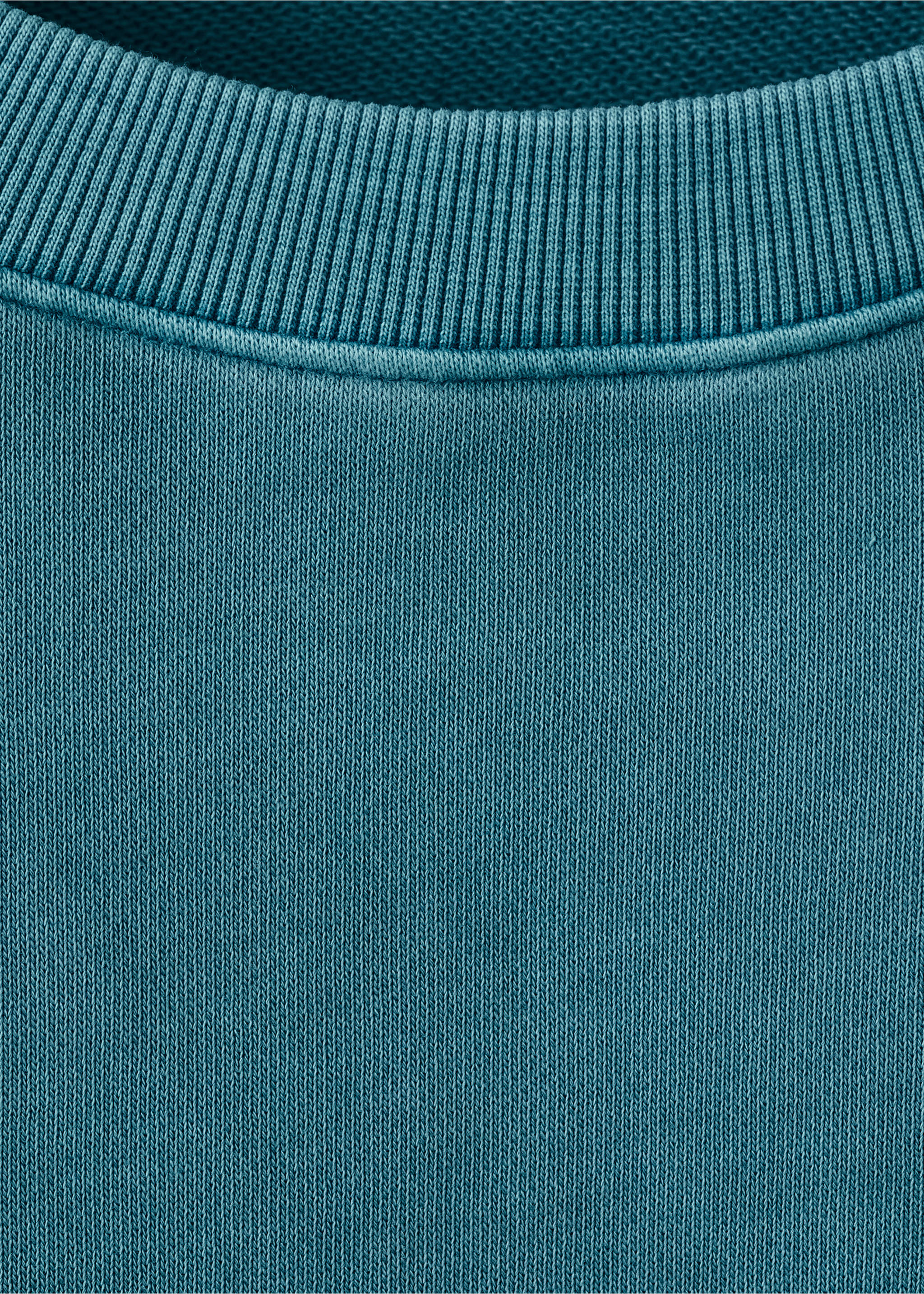 Teal sweatshirt close-up showing the ribbed crew neckline., Petrol Blue. Ref: 27024778-00.
