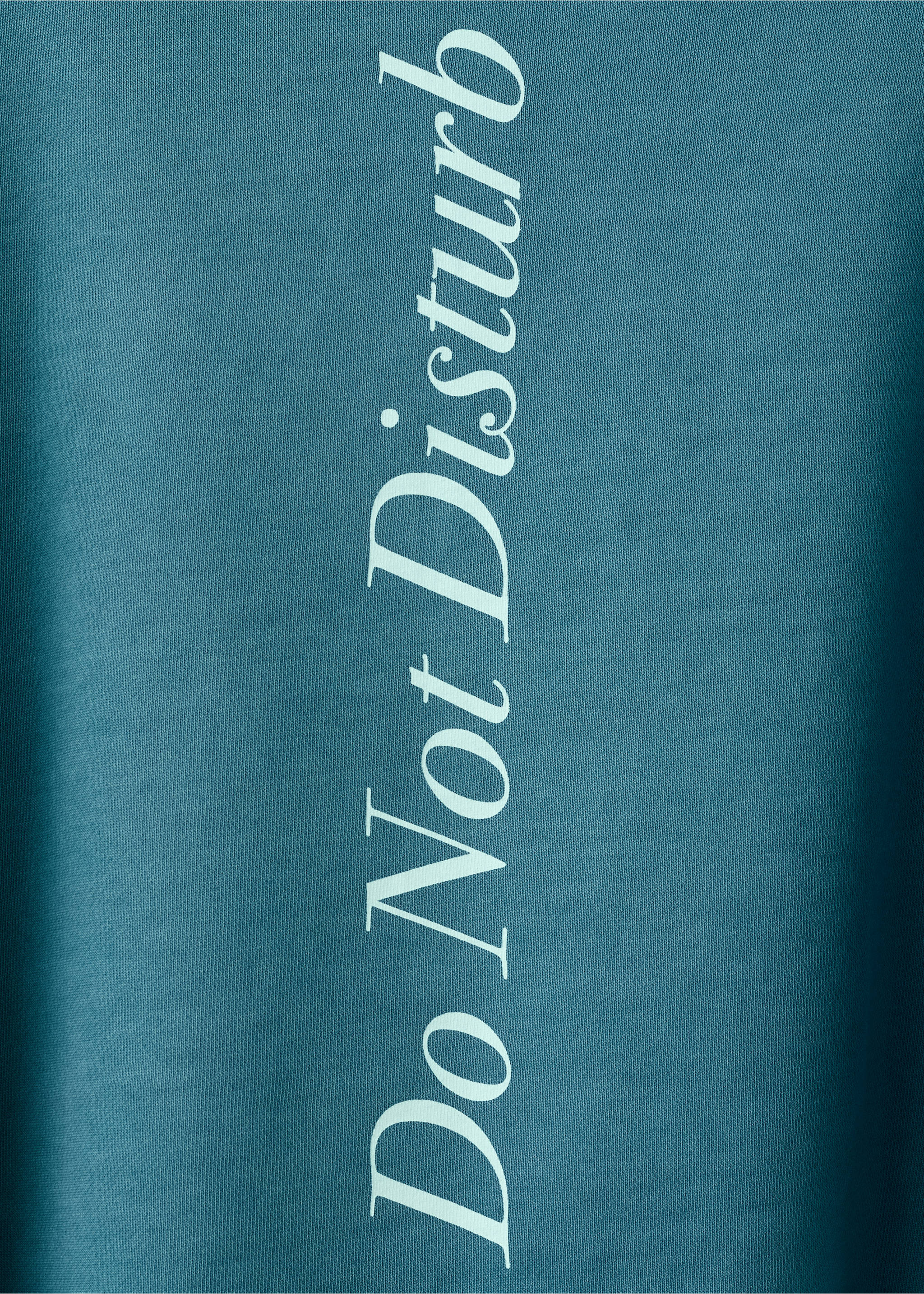 Dark teal sweatshirt fabric detail with vertical white text., Petrol Blue. Ref: 27024778-00.