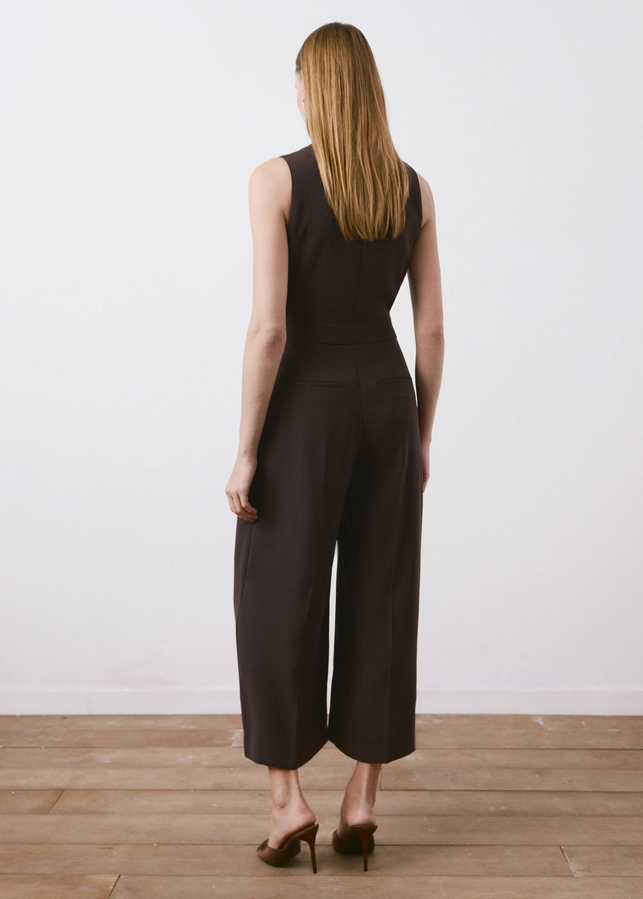 Back view of a dark brown sleeveless wide-leg jumpsuit.