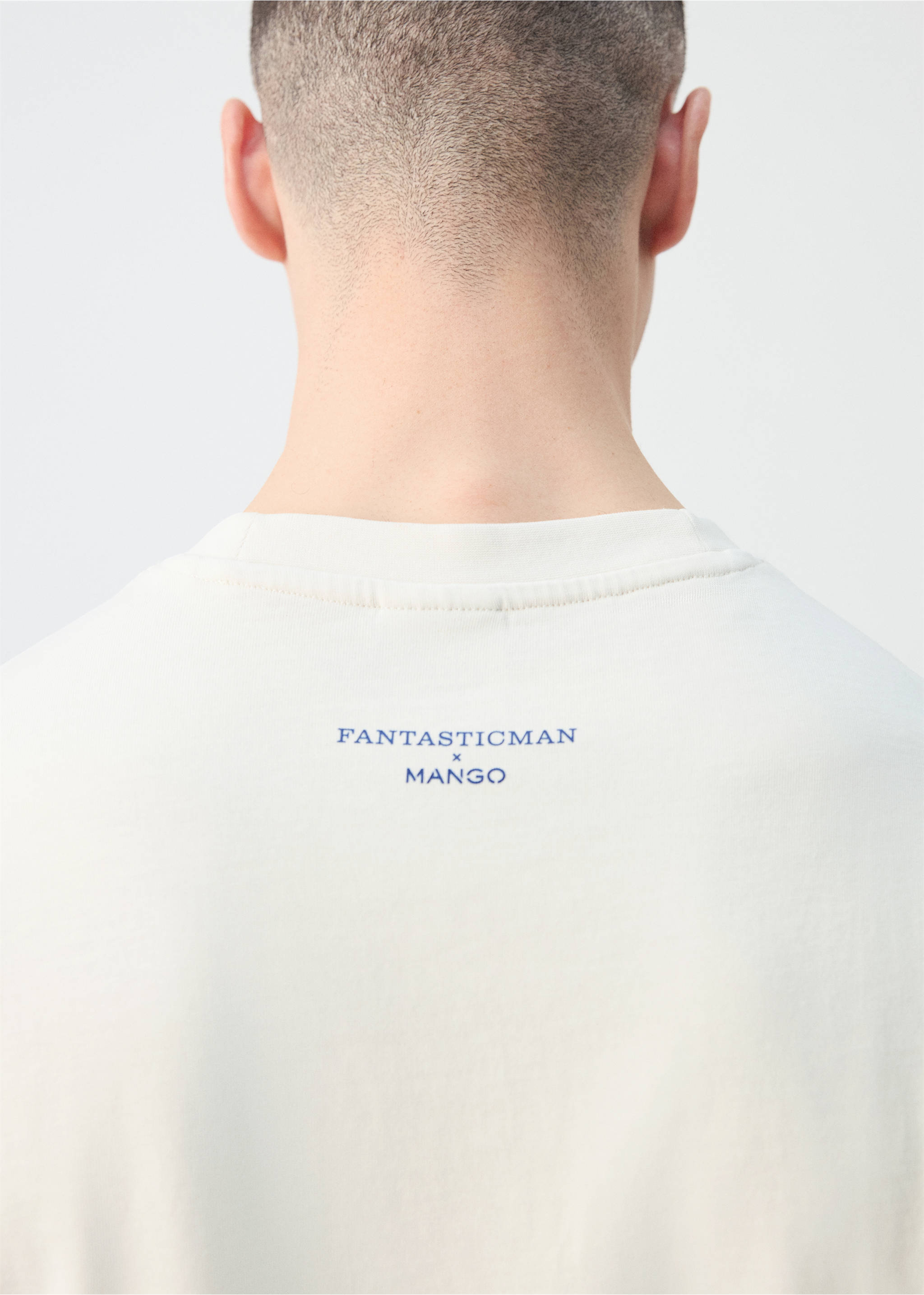 Back detail of a light t-shirt with a blue logo print below the collar., Off White. Ref: 27025993-00.