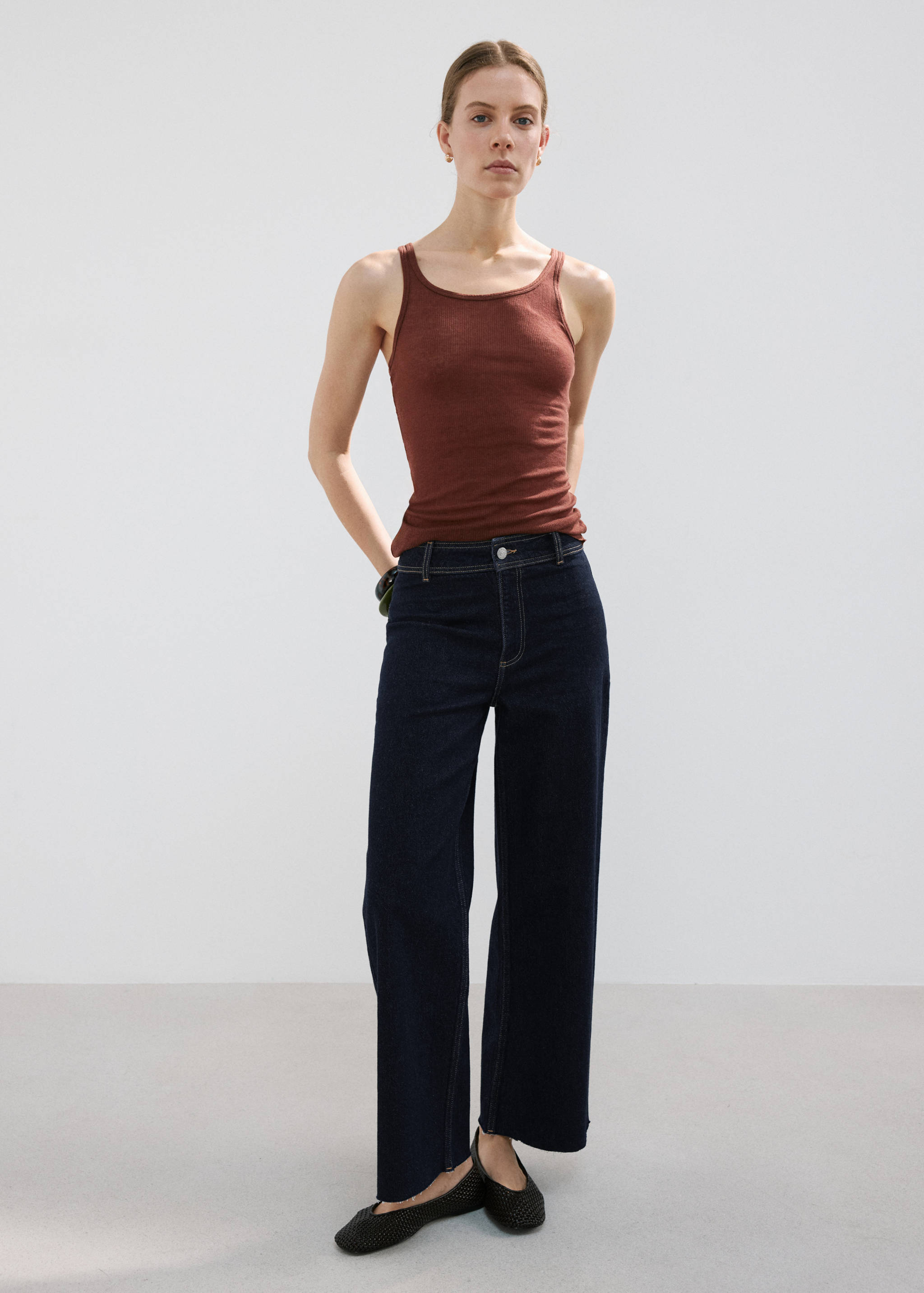 Dark wash wide-leg denim trousers with contrast topstitching, styled as an outfit.