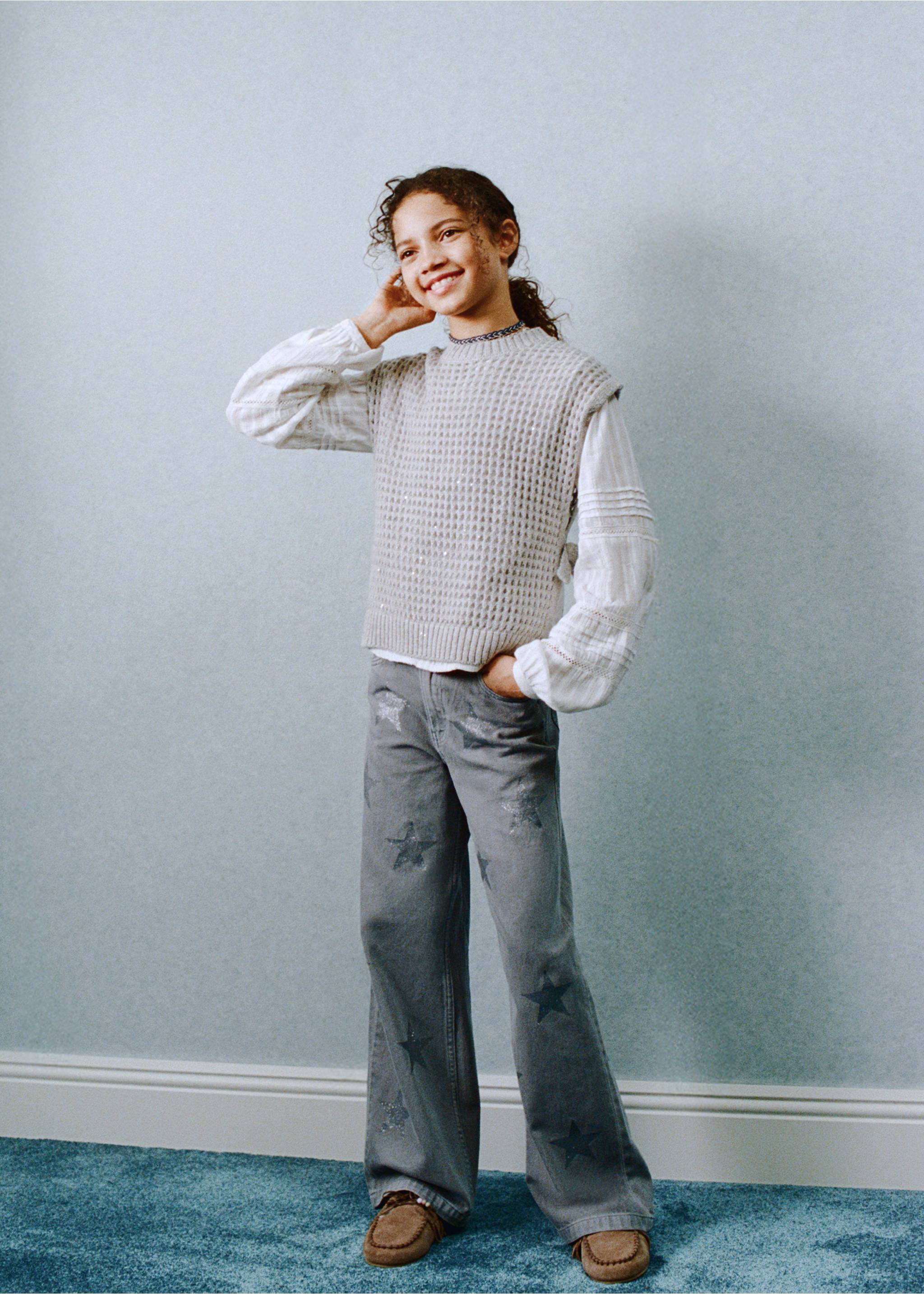 Grey star-print denim trousers worn with a cream knit vest, Blue. Ref: 27031289-00.