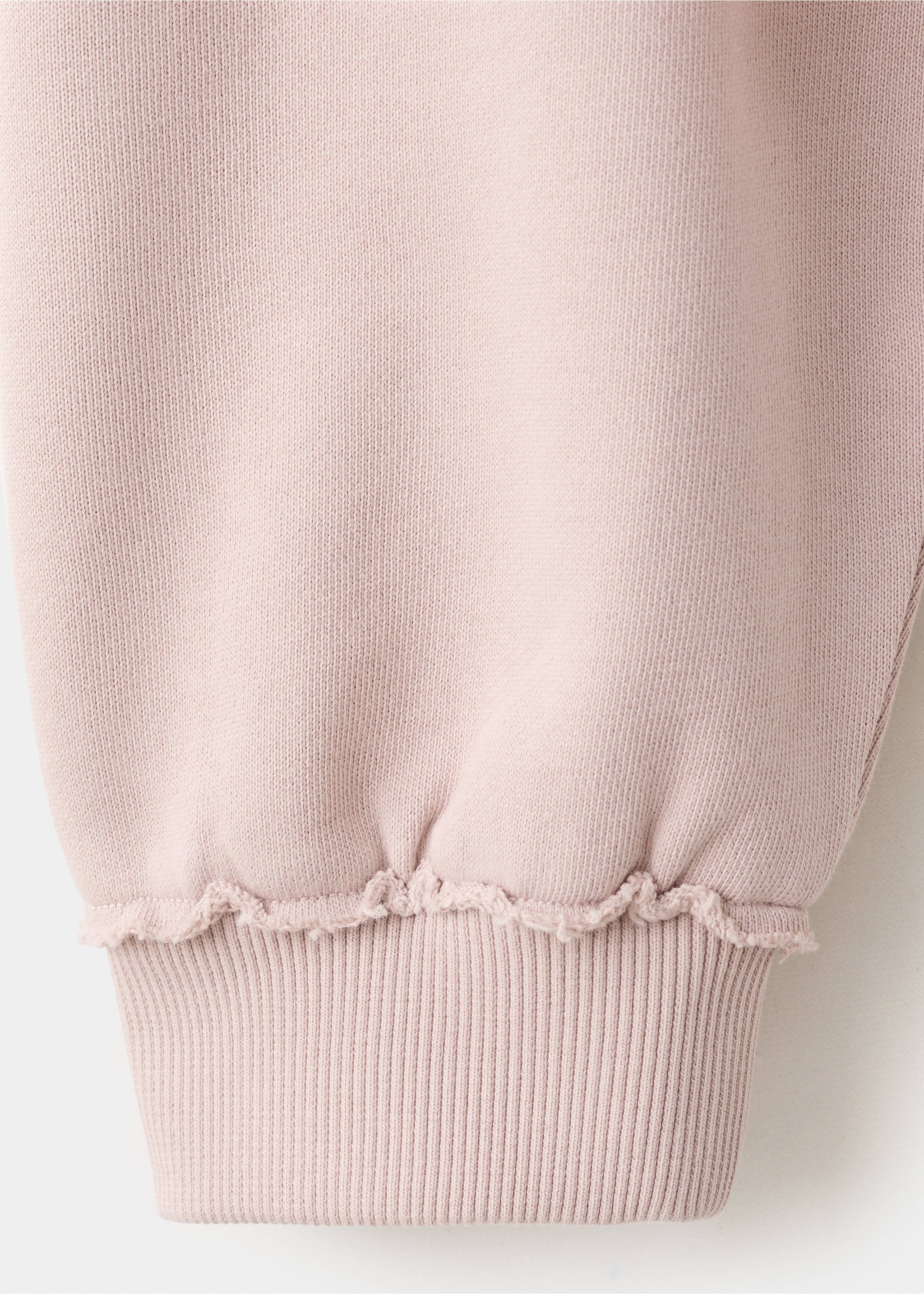 Close-up of the ribbed cuff and raw edge on a pink sweatshirt., Pink. Ref: 27031517-00.