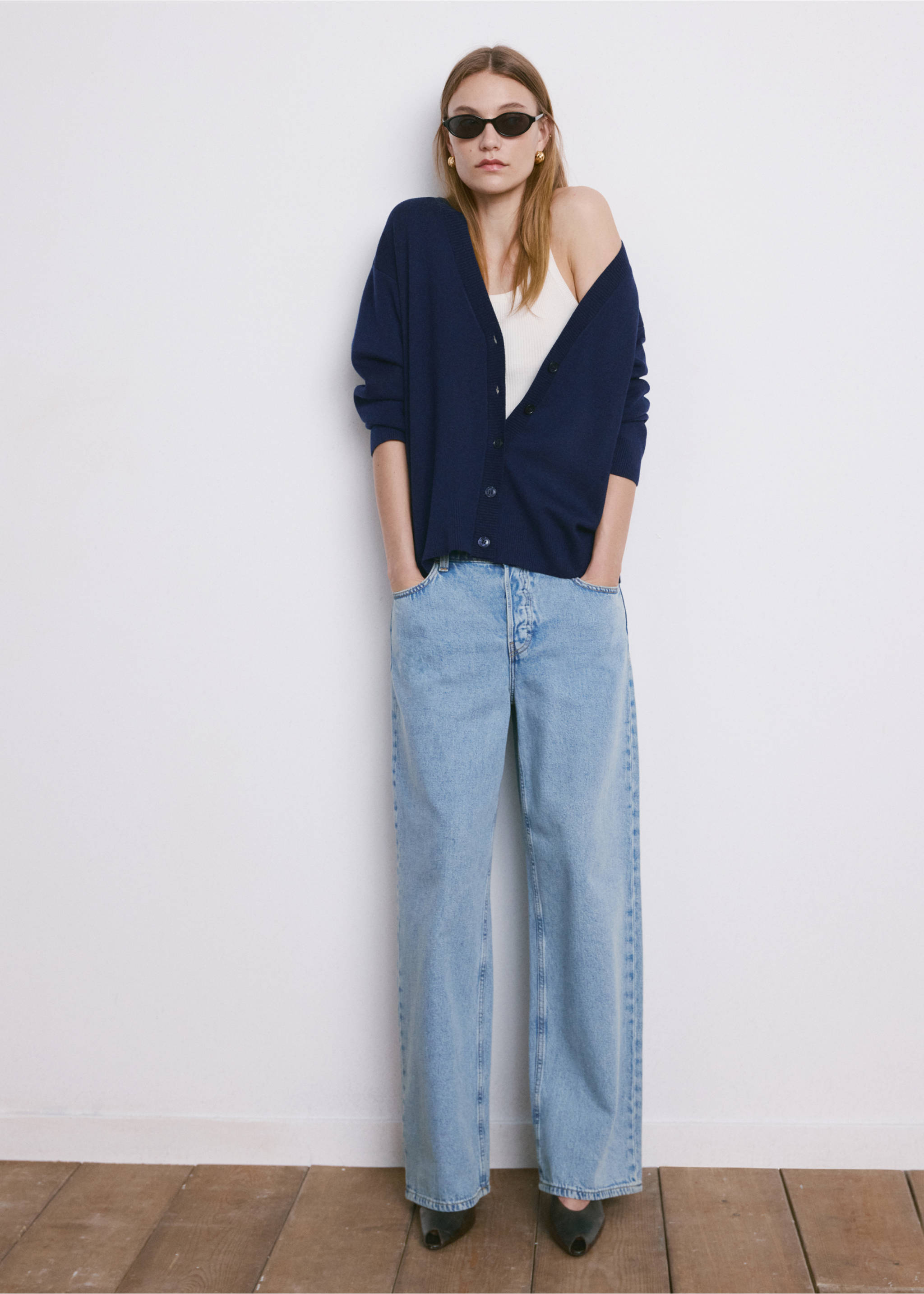 Navy blue V-neck cardigan worn with light blue wide-leg jeans., Dark Navy. Ref: 27034774-00.