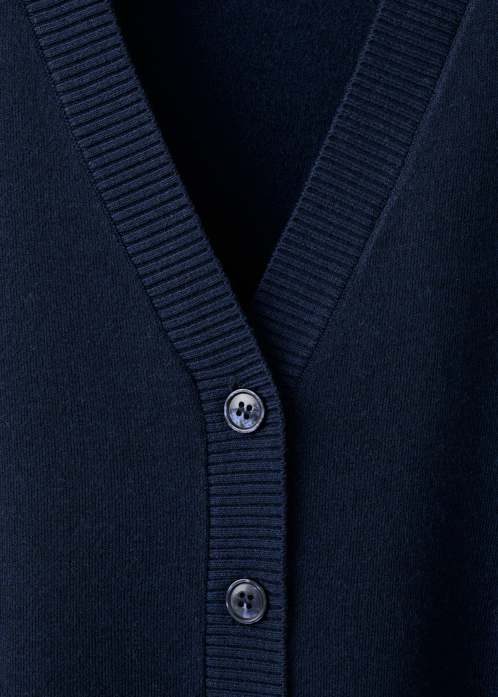 Navy blue knit cardigan V-neck detail with buttons.